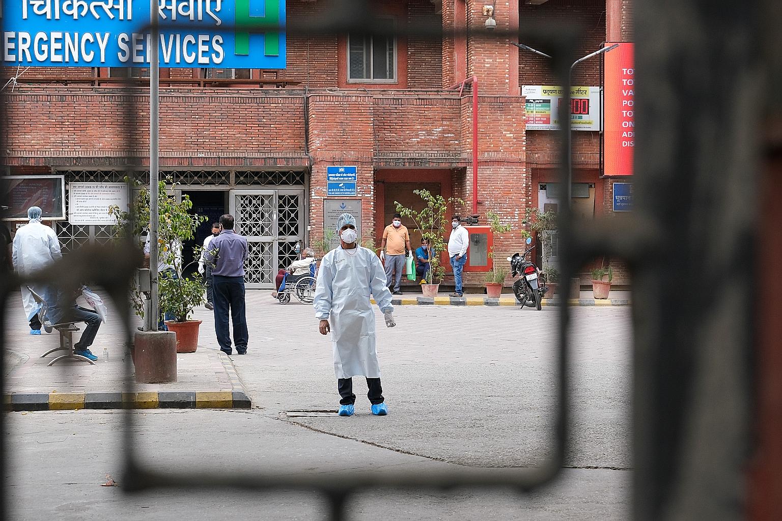 A medical worker in the courtyard of the Lok Nayak Hospital in New Delhi on Tuesday. On that day, Delhi registered a new high of 28,395 fresh cases and 277 deaths as it battles deadlier and more infectious variants of the coronavirus. It is under a w