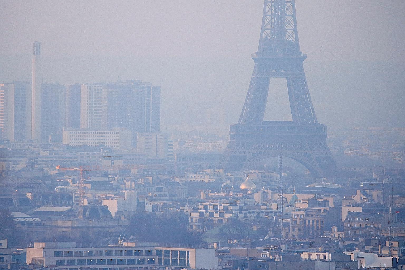 The Eiffel Tower and other buildings in Paris shrouded in haze in December 2016, as the City of Light experienced the worst air pollution in a decade. PHOTO: REUTERS
