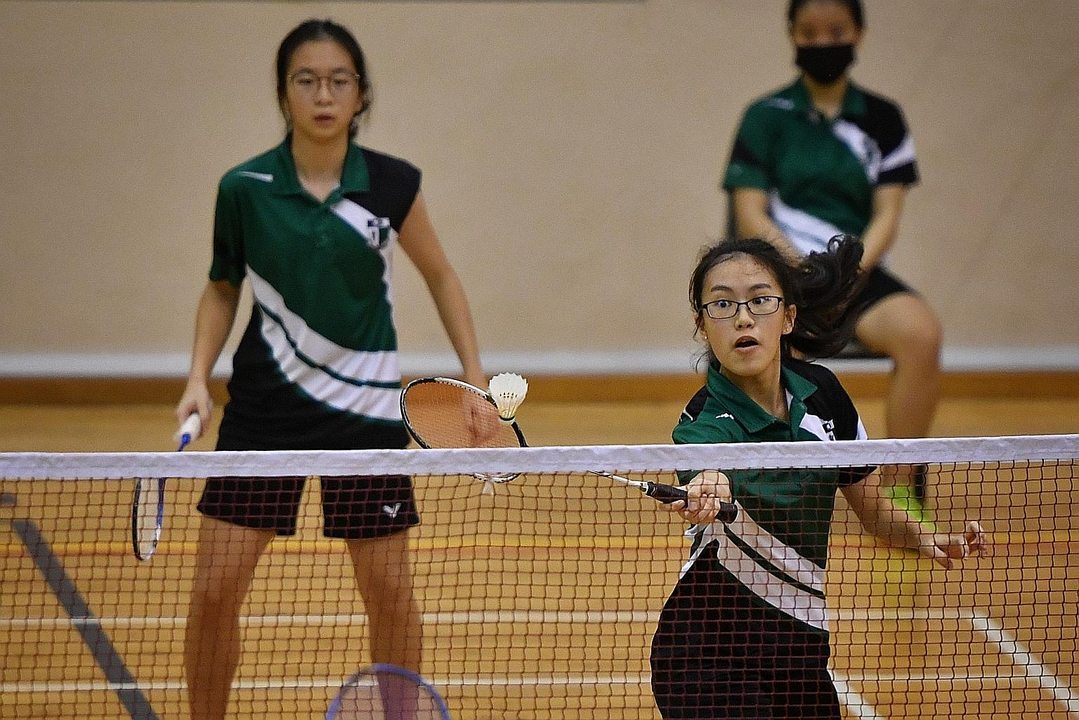 Raffles Girls' School captain Ashlyn Chua (left), vice-captain Zion Seng and the rest of their team romped to the B division South Zone title with a 5-0 win over Fairfield Methodist School (Secondary) yesterday.