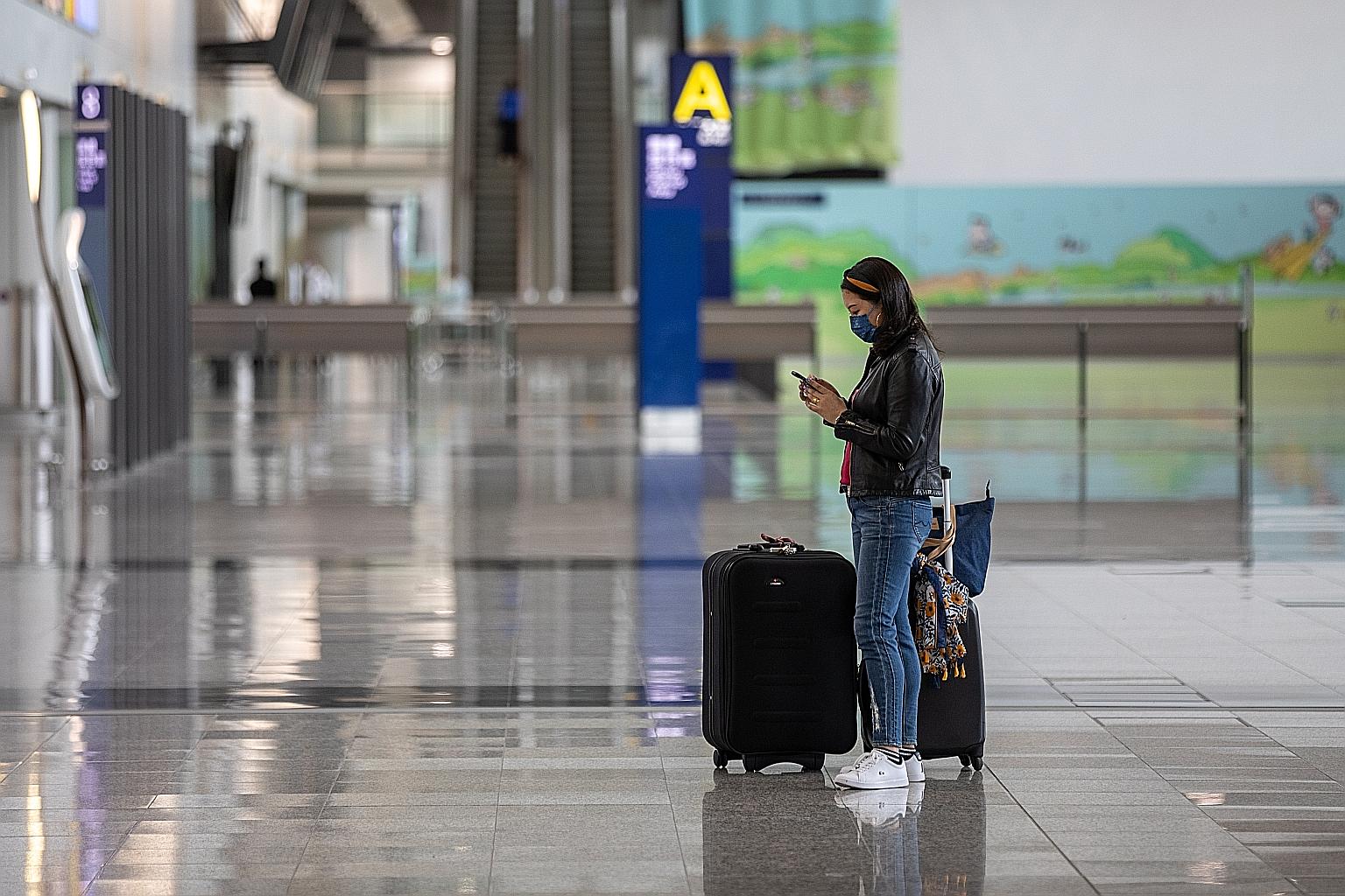 A traveller at Hong Kong International Airport on Tuesday. Initiatives such as travel bubbles can be lauched only when it is safe to do so, Education Minister Lawrence Wong said yesterday. PHOTO: EPA-EFE