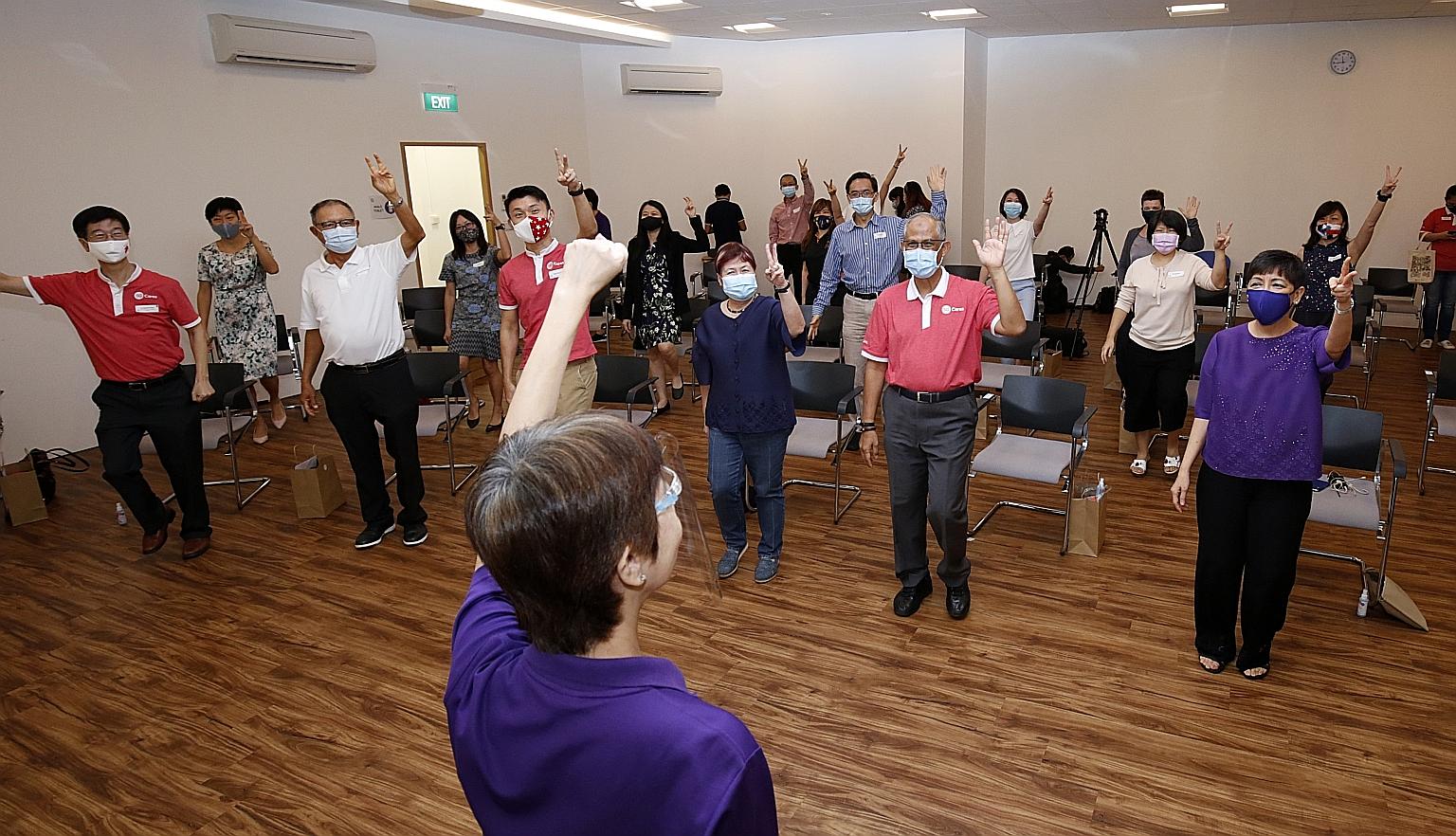 Minister for Social and Family Development Masagos Zulkifli (right) taking part in a game with other guests, including Tampines GRC MP Baey Yam Keng (third from right), at the centre's launch yesterday. PHOTO: LIANHE ZAOBAO