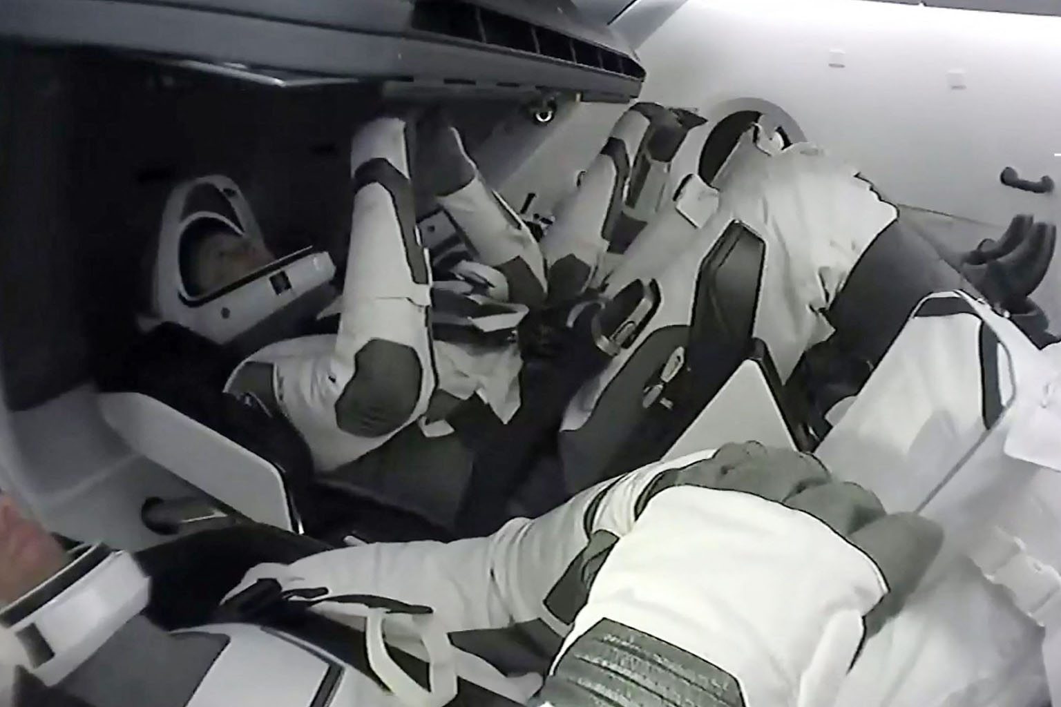 A screengrab from Nasa's live feed shows the astronauts aboard the Endeavour spacecraft after docking at the International Space Station yesterday. It was the first time a capsule was reused for crewed spaceflight.