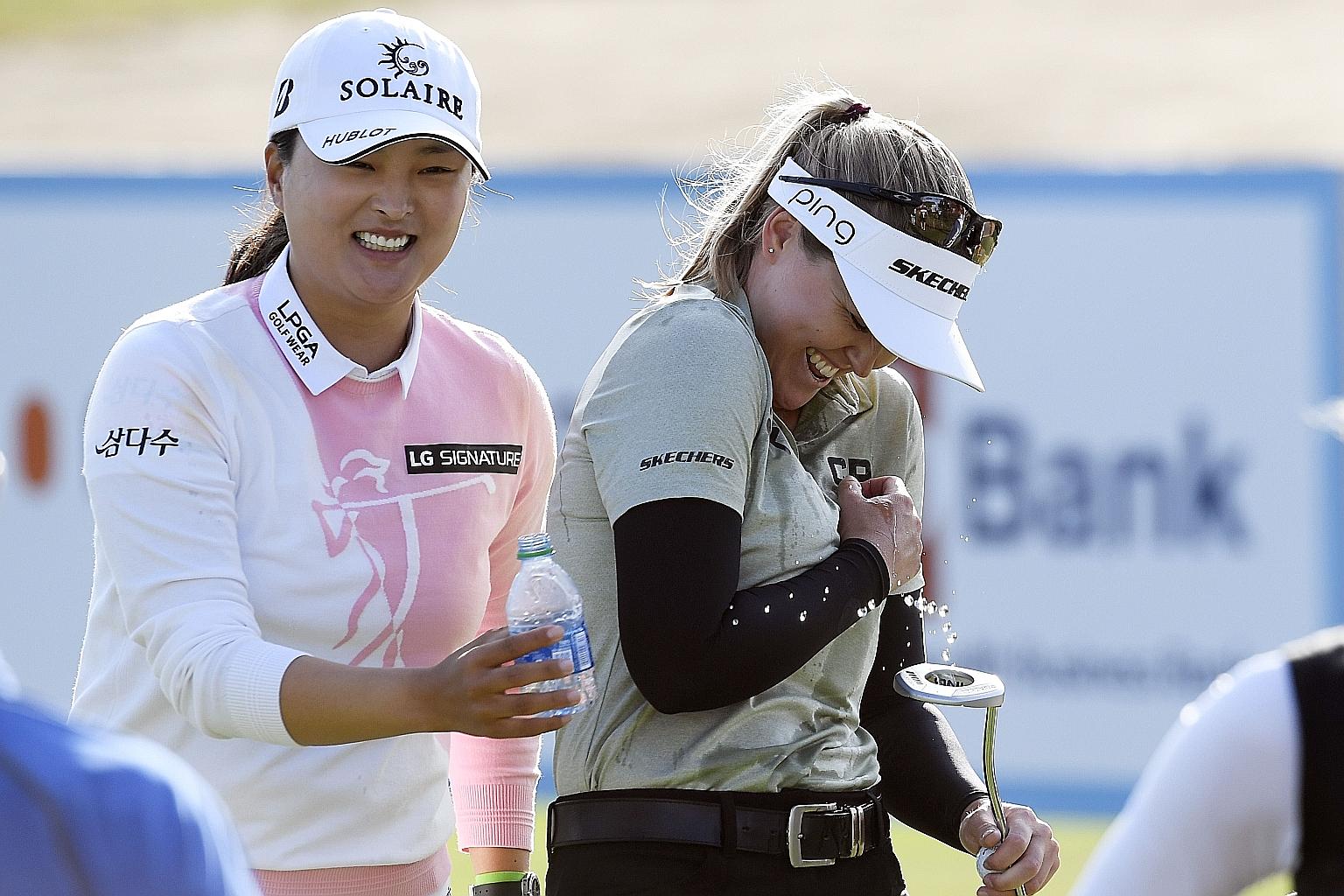 Brooke Henderson is doused with water by Ko Jin-young of South Korea after the Canadian won the LA Open on Saturday.