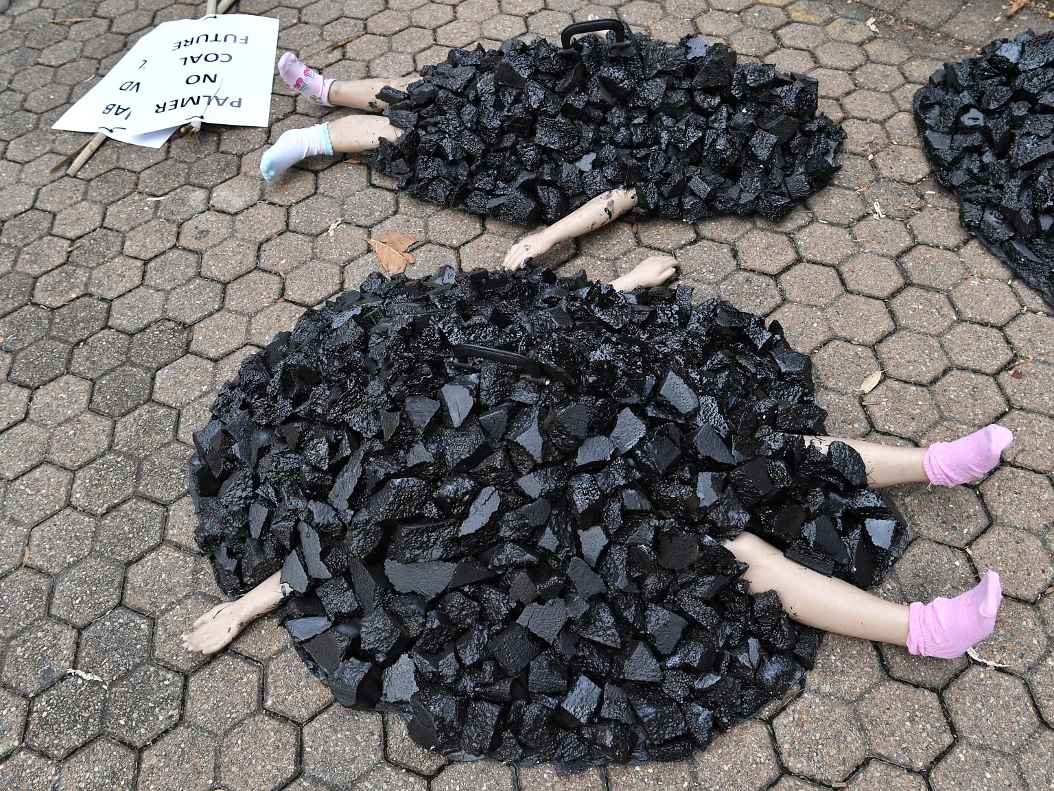 Mannequins depicting children covered in coal at an Extinction Rebellion protest in Brisbane, Australia, last week. The country has the world's fourth-largest coal reserves. PHOTO: EPA-EFE