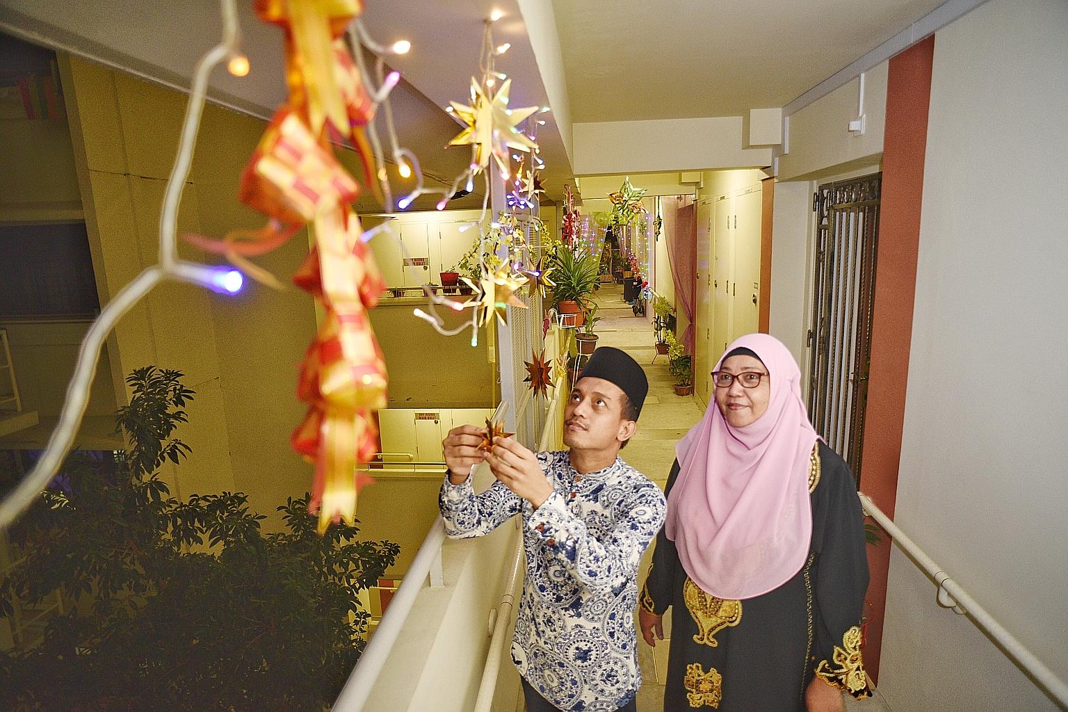 Mr Abdullah Abdul Rahman and his neighbour, Madam Rashida A. Rahman, have put up festive decorations along the fourth-floor corridor of Block 117 Tampines Street 11. ST PHOTO: DESMOND WEE