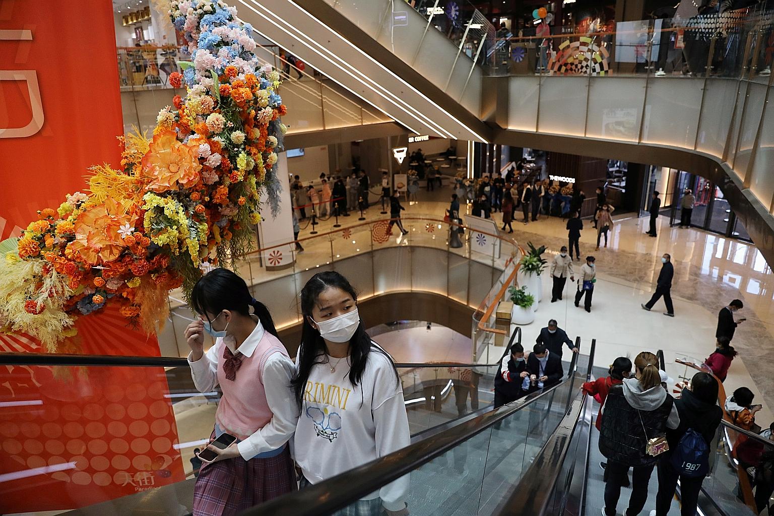 People visiting a newly opened shopping mall in Beijing earlier this month. China's retail sales surged 34.2 per cent year on year last month, surpassing a 28 per cent gain expected by analysts. PHOTO: REUTERS