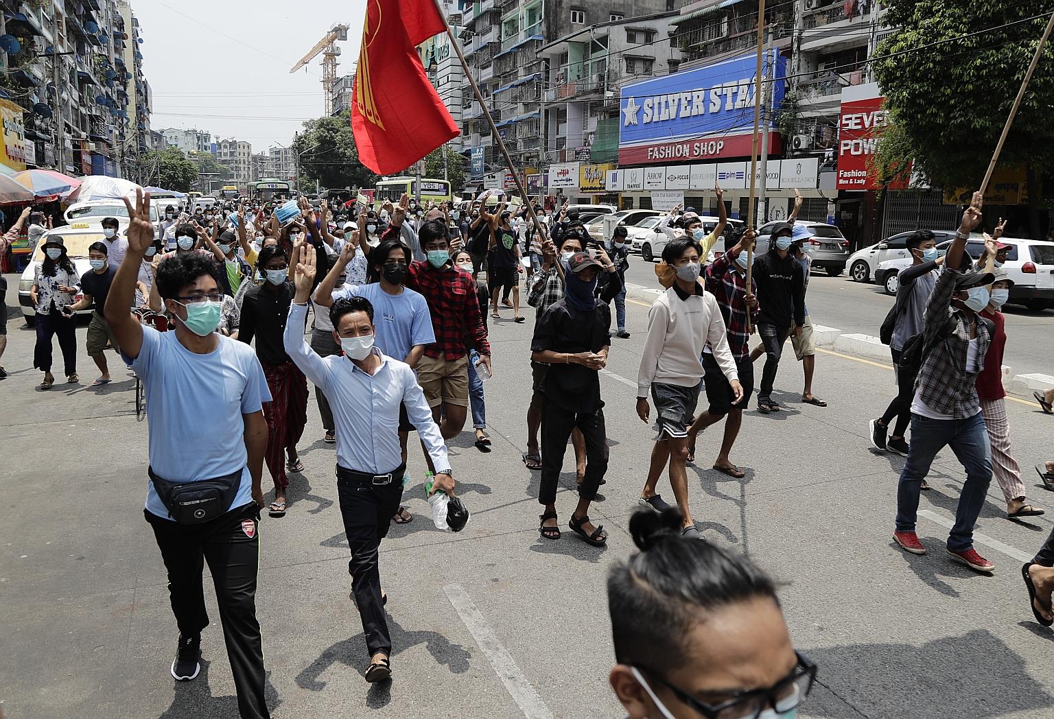 Demonstrators flashing the three-finger salute during an anti-military coup march in Yangon, Myanmar, yesterday. Protest leaders say the results of the special Asean summit in Jakarta "do not reflect the views and voices of the Myanmar people and wil