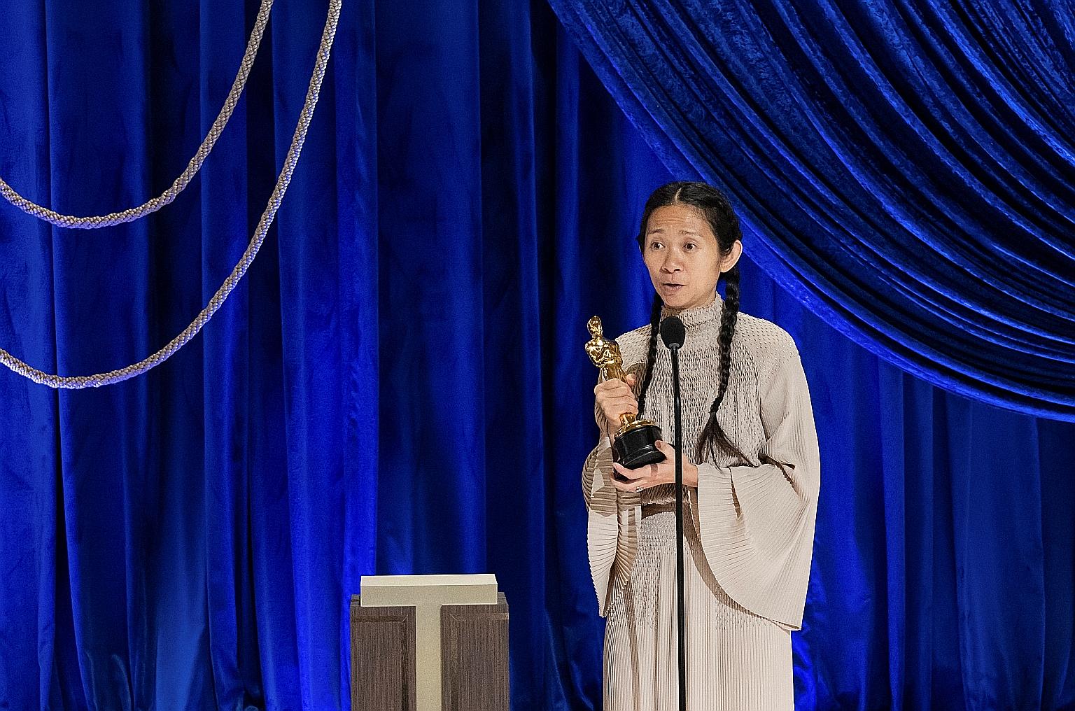Chloe Zhao (above) accepting her Best Director award for the drama Nomadland at the Oscars in Los Angeles yesterday morning, Singapore time. Youn Yuh-jung (below) won Best Supporting Actress for her role in the immigrant drama Minari.