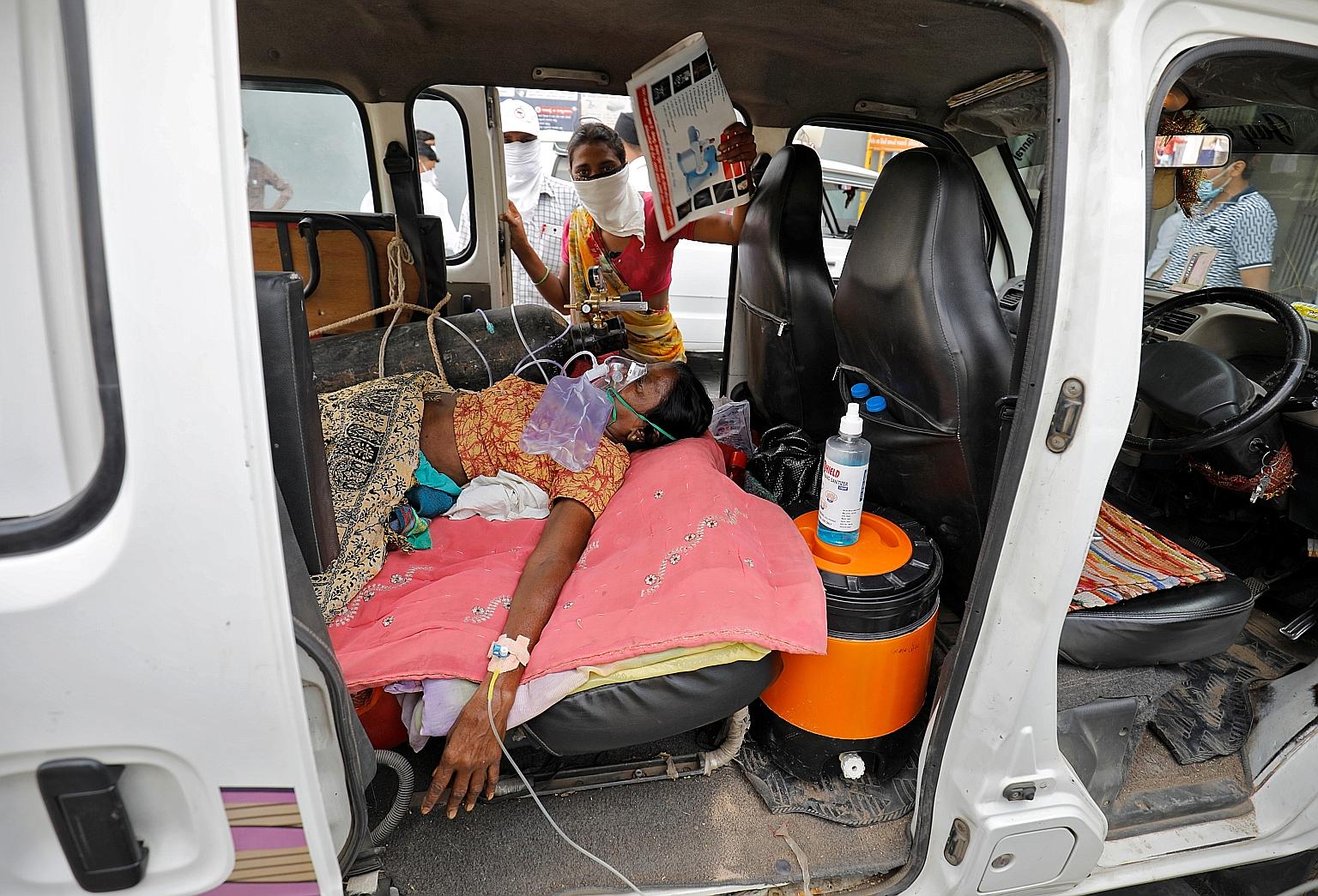 A patient with an oxygen mask inside a vehicle waiting for a bed to be available at a Covid-19 hospital in the western Indian city of Ahmedabad yesterday.