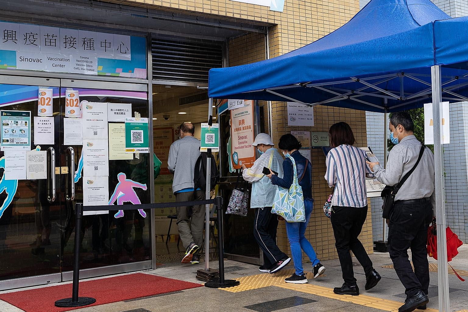 People queueing at a community vaccination centre in Hong Kong last Saturday. Officials have reiterated that there is enough vaccine supply to go around, but only about 11 per cent of the 7.5 million population have received at least one dose. So far