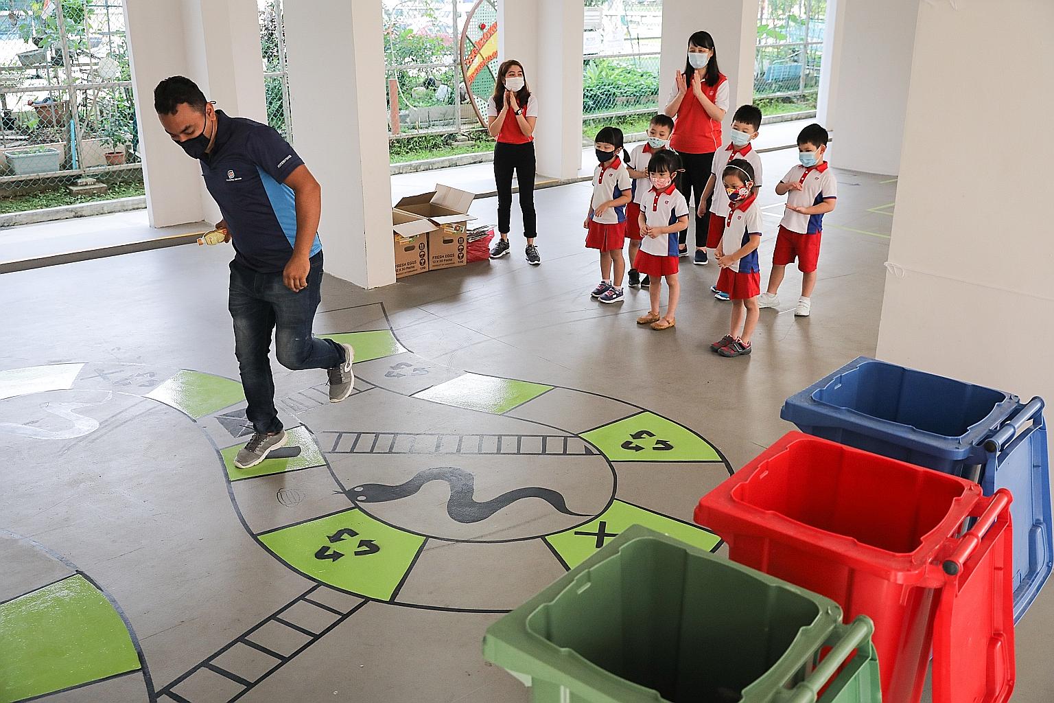 Mr Islam Tarikul, 28, a cleaner from Bangladesh who has worked with Chua Chu Kang Town Council for four years, taking part in a game of snakes and ladders with Kindergarten 2 pupils from PCF Sparkletots @ Chua Chu Kang Block 123 last Wednesday. This