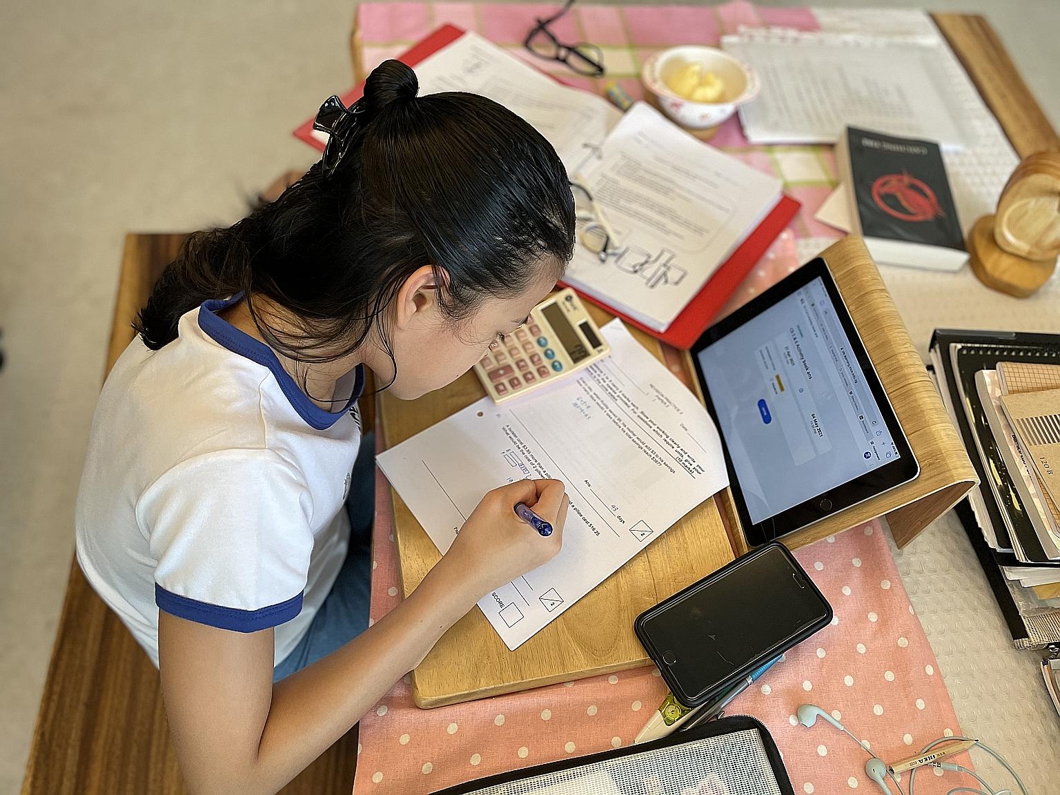 Primary 6 pupil Oh Sue-Ann, 11, who will be taking the PSLE this year under the new scoring system, which will score each standard-level PSLE subject using eight bands known as achievement levels. Zhonghua Primary School pupils after they had collect