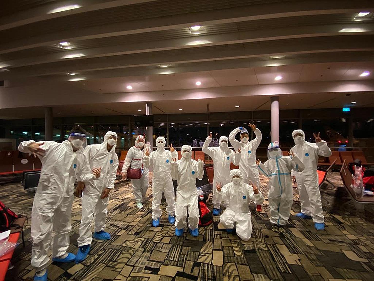 Members of the 12-strong Singapore diving contingent donning personal protective equipment at Changi Airport on Monday night, before departing for the Fina Diving World Cup in Tokyo. The move is part of the Covid-19 safety measures the Singapore Swim