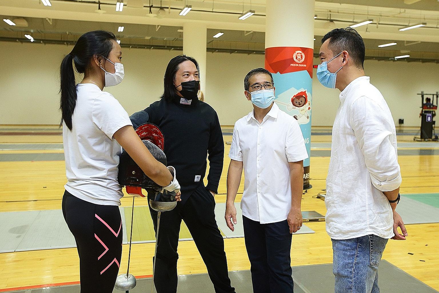 From left: Kiria Tikanah, her coach Henry Koh, Minister for Culture, Community and Youth Edwin Tong, and MCCY parliamentary secretary Eric Chua, during a training session at the OCBC Arena last month.