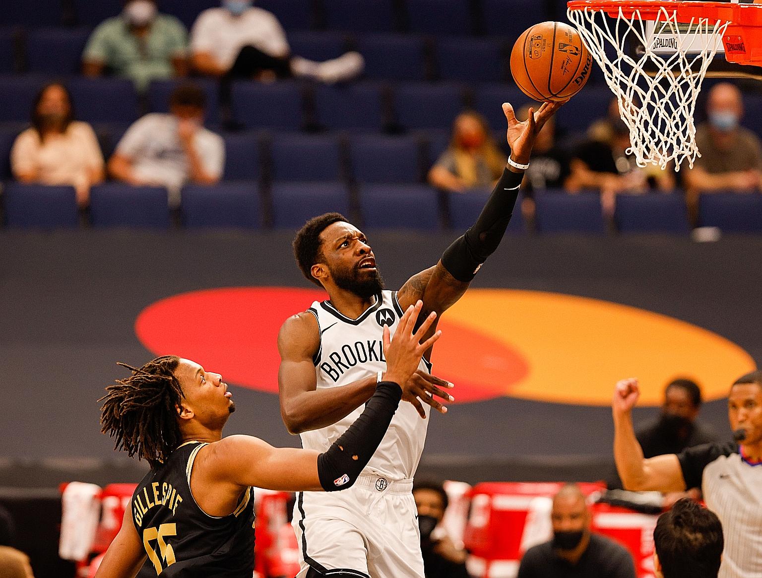 Brooklyn forward Jeff Green driving to the basket over Toronto forward Freddie Gillespie in their 116-103 win at Amalie Arena in Tampa, Florida.