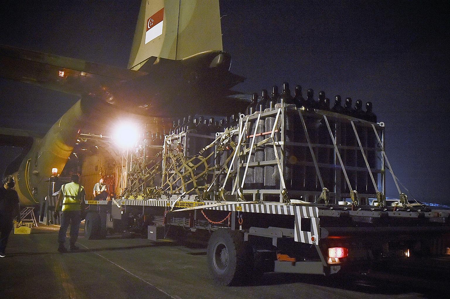 Oxygen cylinders being loaded onto one of the two C-130 aircraft that were sent to the Indian state of West Bengal from Singapore yesterday.