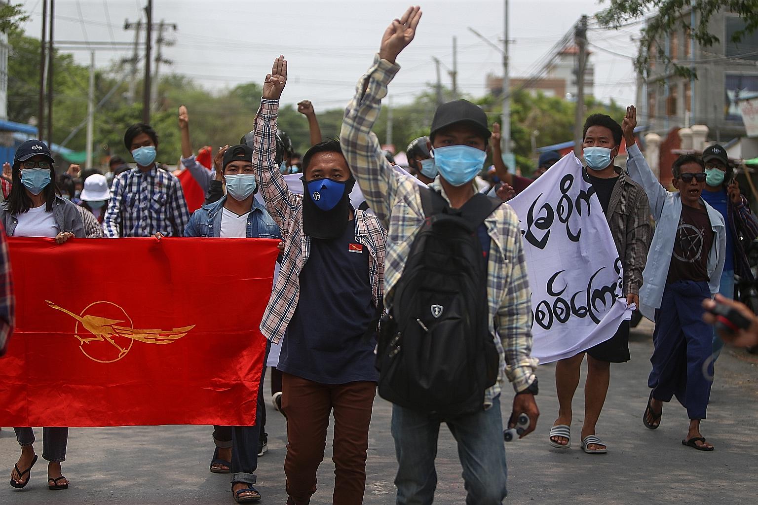 Demonstrators flashing the three-finger salute during an anti-military coup protest in Mandalay, Myanmar, yesterday. Pro-democracy protests have taken place in cities and towns across the country since the Feb 1 military coup. PHOTO: EPA-EFE