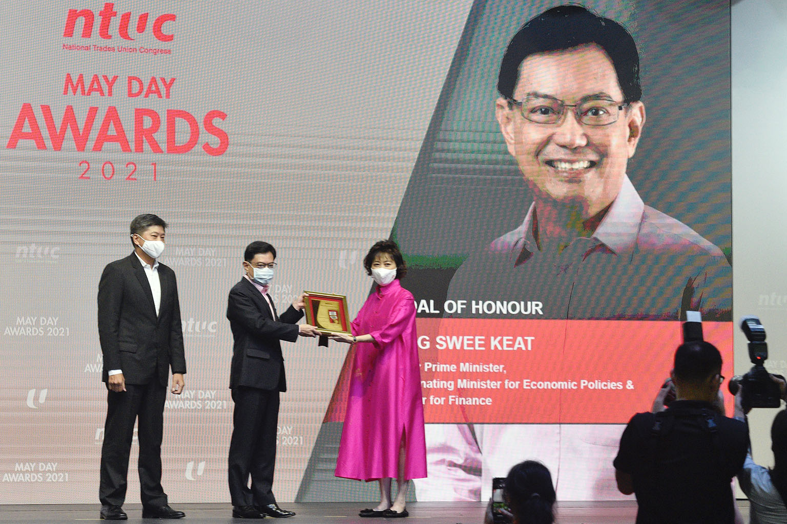 Deputy Prime Minister Heng Swee Keat receiving the Medal of Honour, the top May Day award conferred by the National Trades Union Congress, for helping workers and companies weather the Covid-19 storm last year. The award was handed over yesterday by 