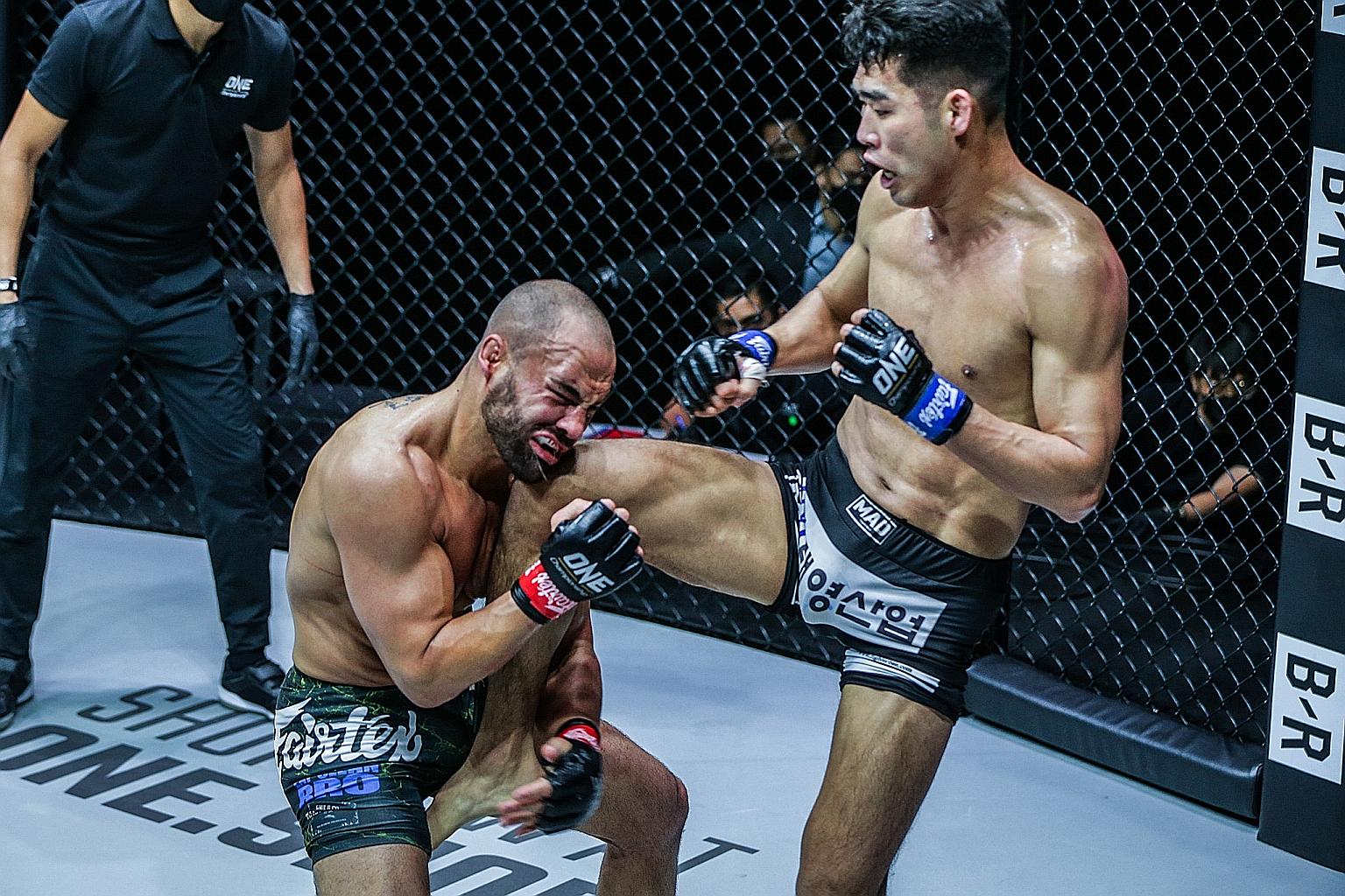 Eddie Alvarez grimacing as South Korean Ok Rae-yoon knees him in the face. The American lost yesterday's lightweight battle at the Singapore Indoor Stadium via unanimous decision.