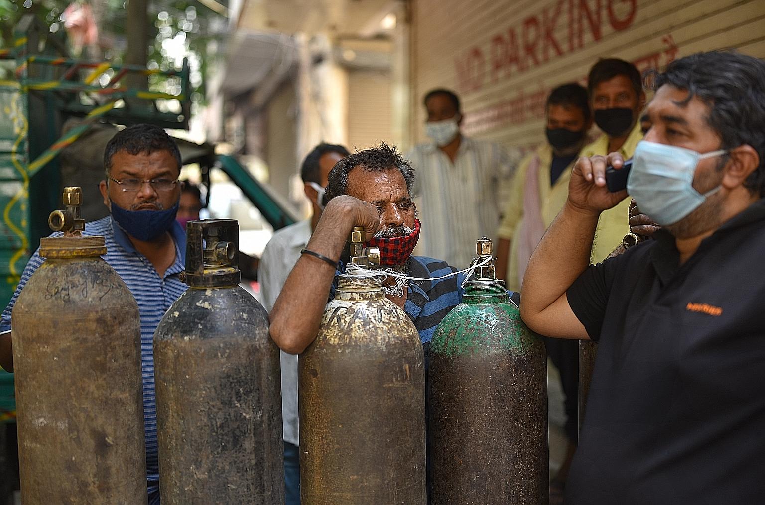 Indians waiting to fill their oxygen cylinders at an oxygen vendor in New Delhi yesterday. International support has become crucial for India as people in its cities are in desperate need of oxygen and medicines. The Indian authorities said nations i