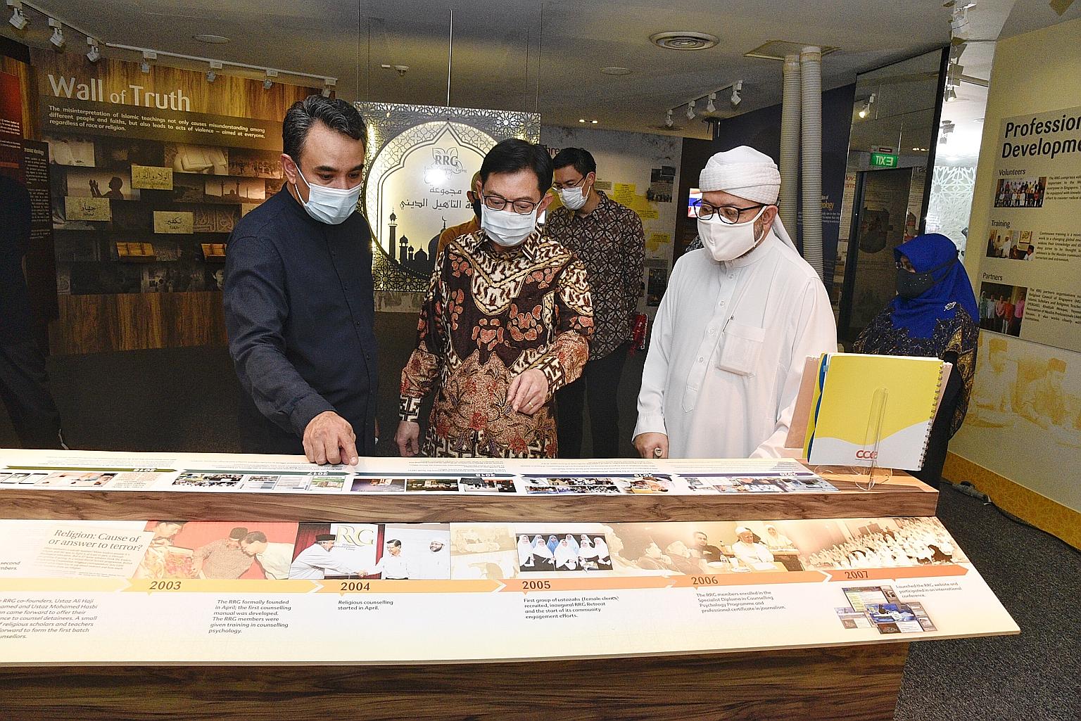 Deputy Prime Minister Heng Swee Keat visiting the gallery of the Resource and Counselling Centre run by the Religious Rehabilitation Group (RRG) at the Khadijah Mosque in Aljunied yesterday. With him are (from far left) RRG vice-chairman Ustaz Mohame