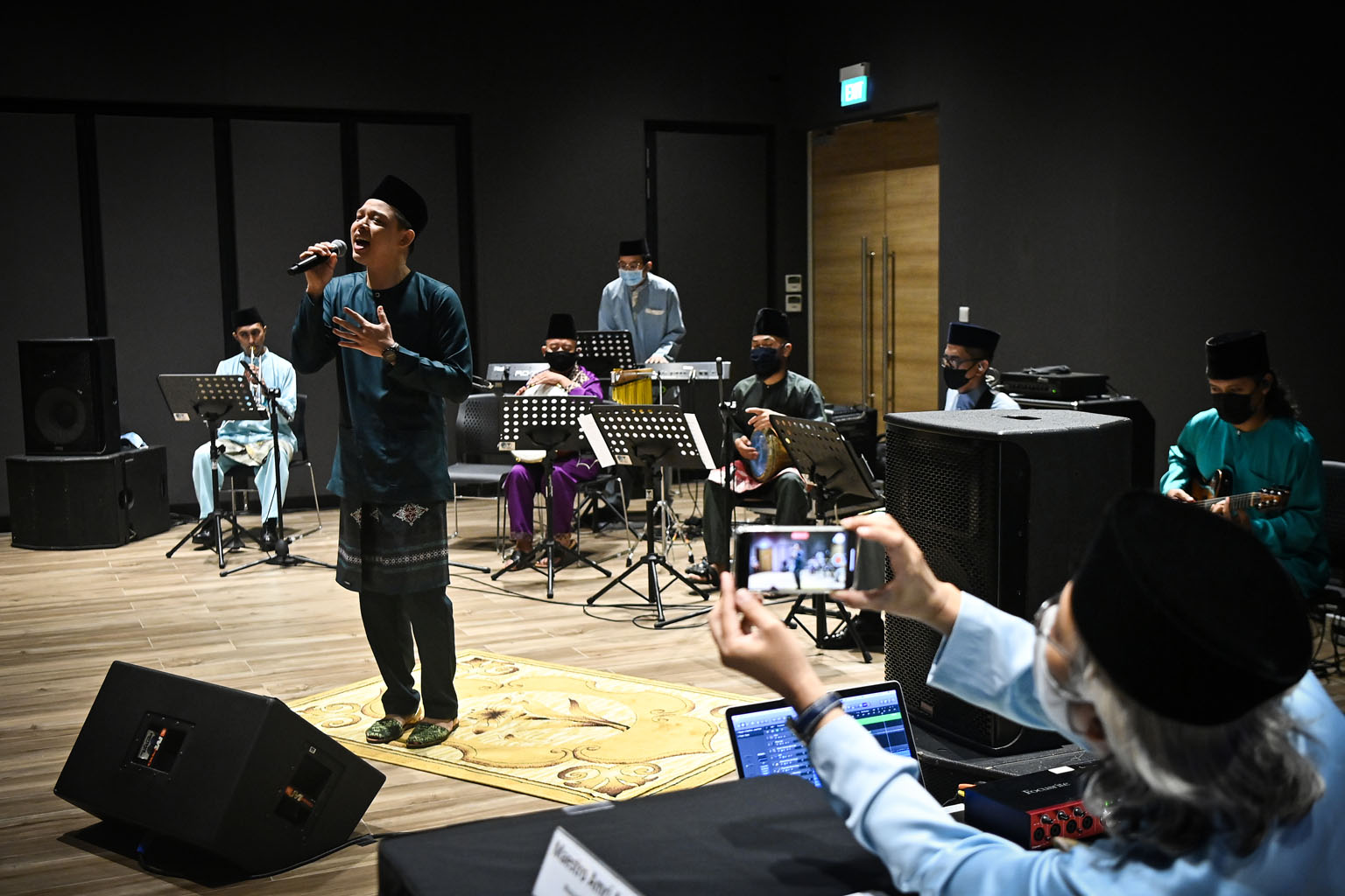 Mr Hady Mirza and the Singapore Malay Orchestra performing Ramadan Yang Mulia, Syawal Yang Indah at Wisma Geylang Serai yesterday. The song, the first of four new ones, was inspired by the Malay/Muslim community celebrating Ramadan and Hari Raya Aidi