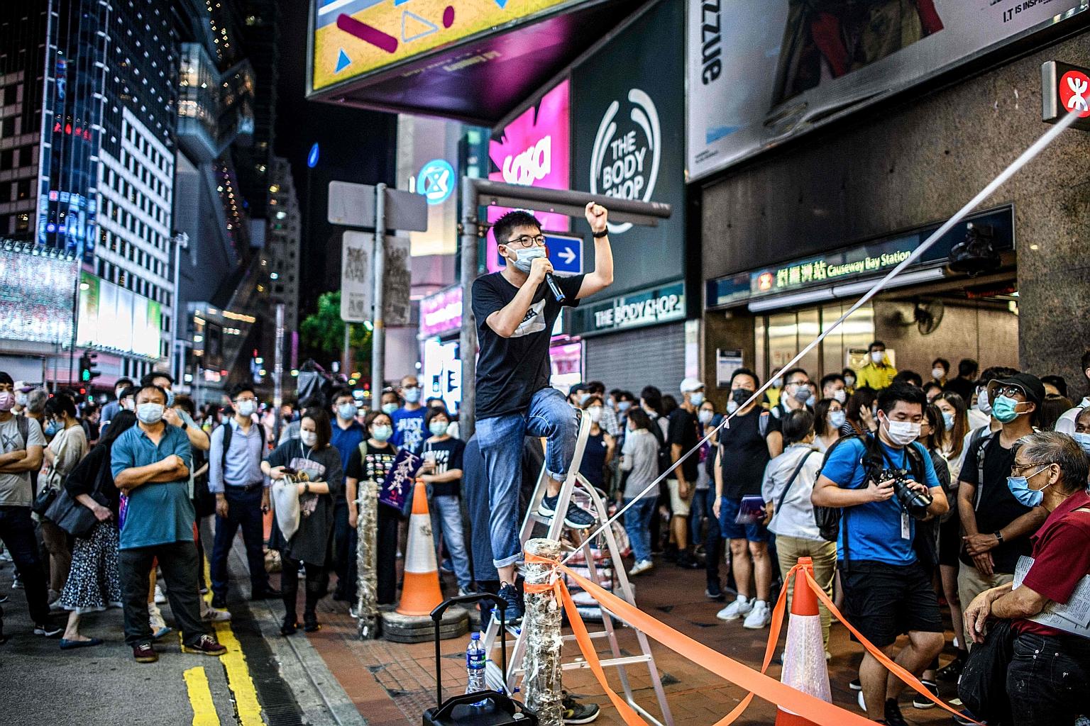 Activist Joshua Wong speaking near Victoria Park on June 4 last year during a vigil marking the Tiananmen Square crackdown in 1989. PHOTO: AGENCE FRANCE-PRESSE