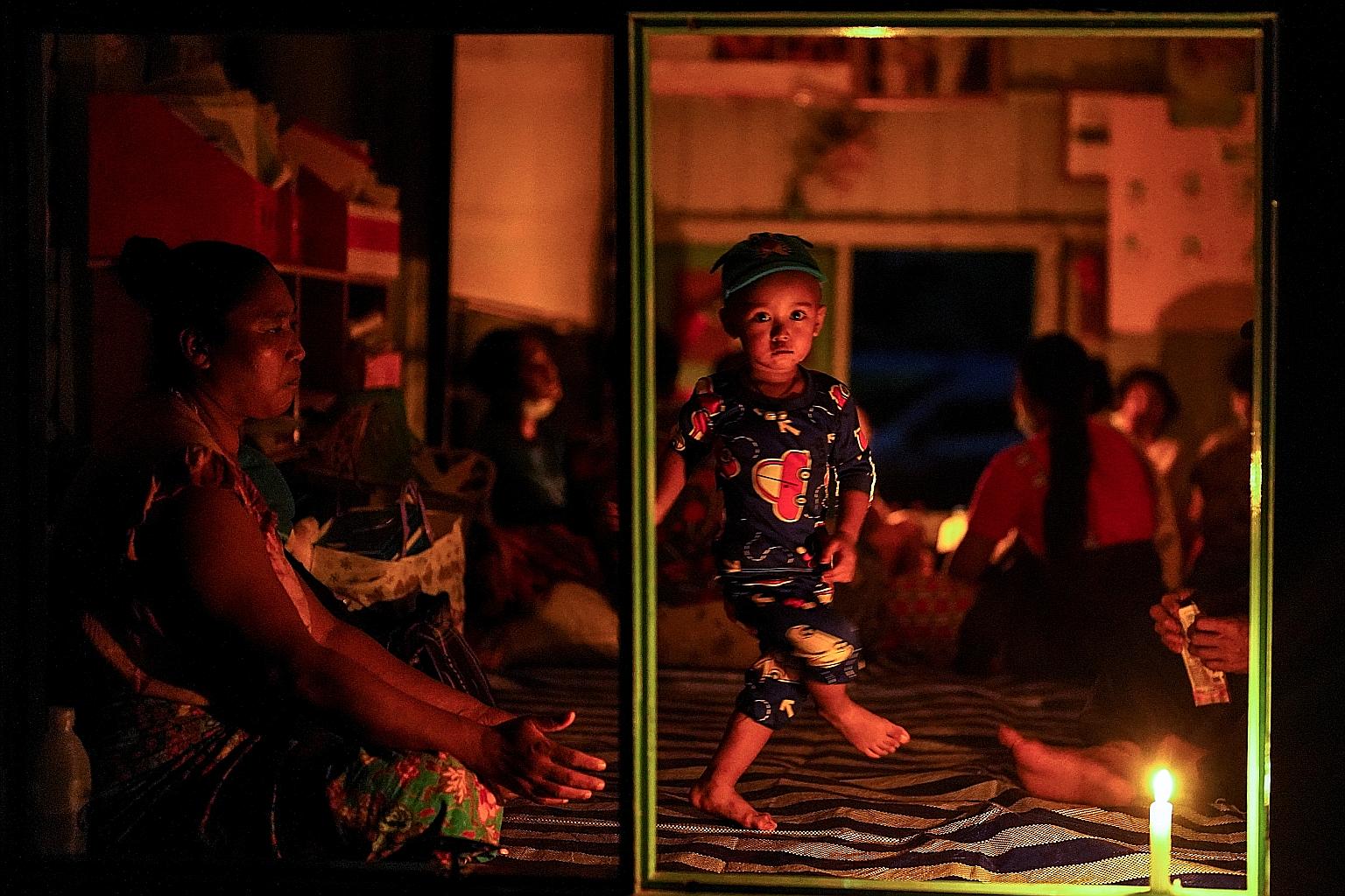 Villagers who fled from Myanmar gathered in the Thai border village of Mae Sam Laep on Tuesday. Fighting between Karen rebels and the Myanmar army has displaced people living on both sides of the border.