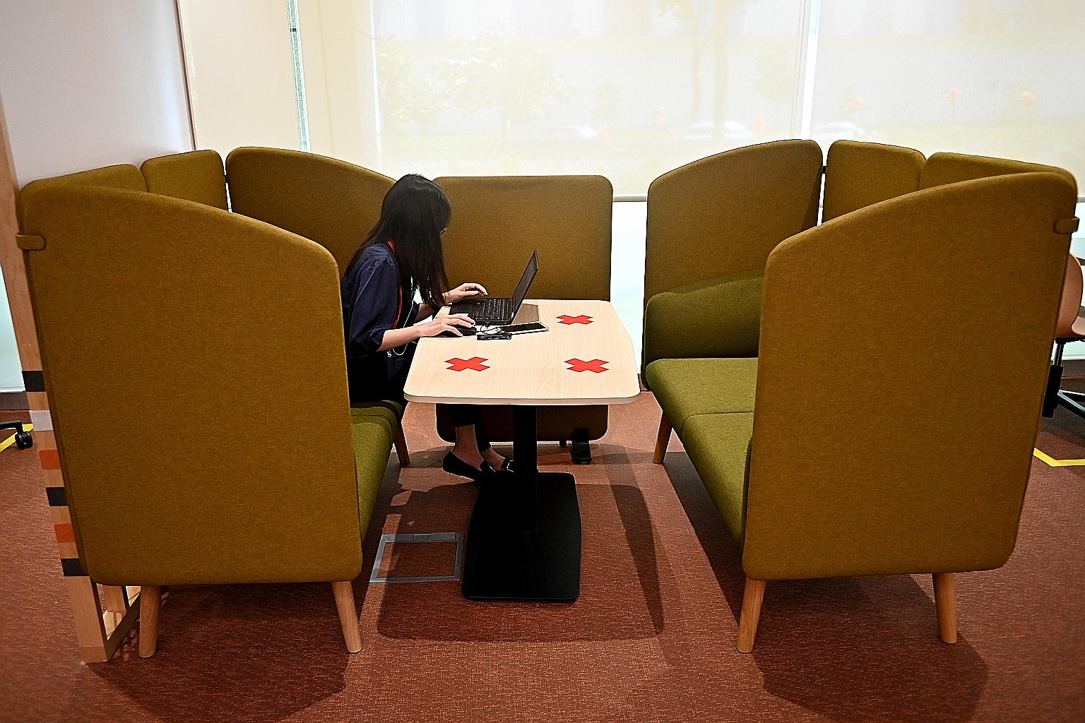 Great Eastern's collaborative workspace on one floor of its Changi premises includes flexi-workspaces (left) and videoconferencing facilities.