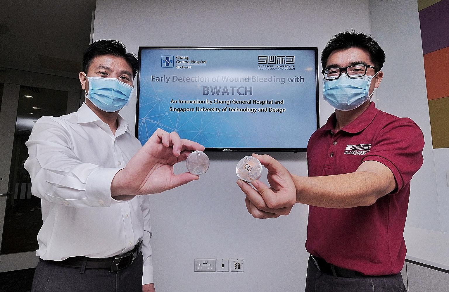 Changi General Hospital's Associate Professor Chionh Chang Yin (far left) and Singapore University of Technology and Design's Associate Professor Foong Shaohui with the BWATCH sensor. The wireless, lightweight device is placed over a patient's bandag