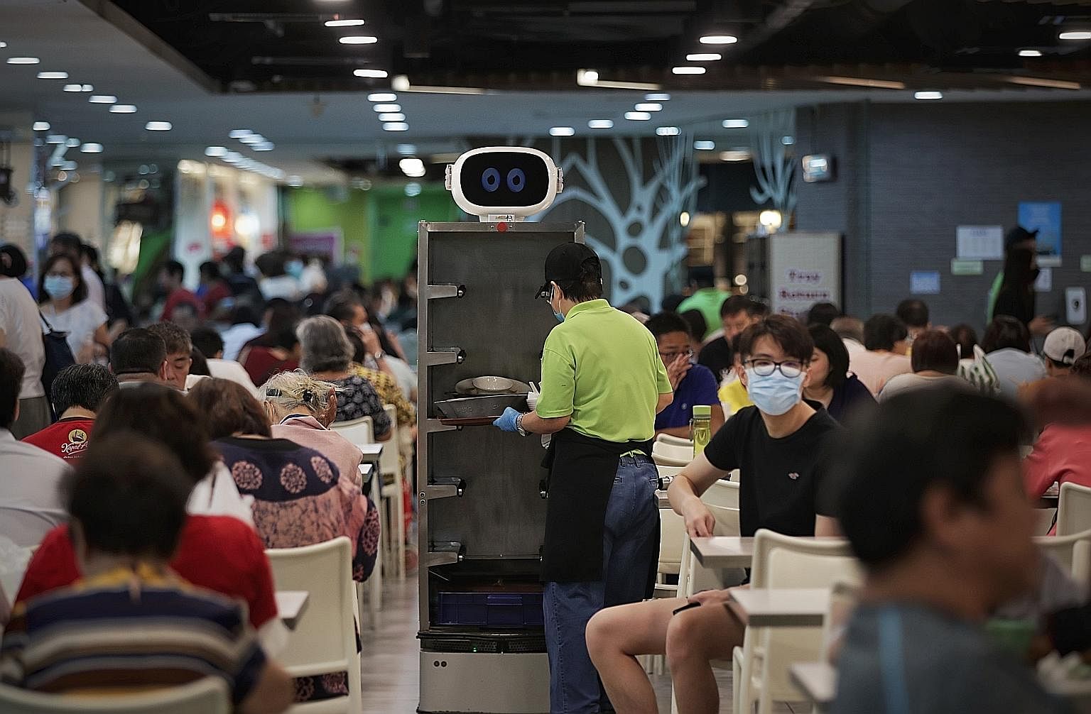 A Smart Tray Return Robot at Gourmet Paradise in Toa Payoh. A tray return station at Bukit Merah Central Food Centre. The Kopitiam @ Our Tampines Hub foodcourt.
