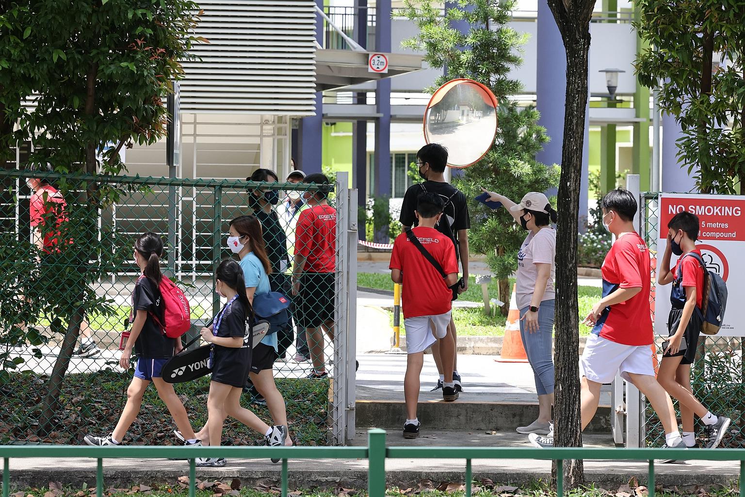 Students arriving at Edgefield Secondary School in Punggol to get tested for Covid-19 yesterday, after a student at the school recently tested positive. A Ministry of Education spokesman said 99 per cent of students, staff and external vendors schedu