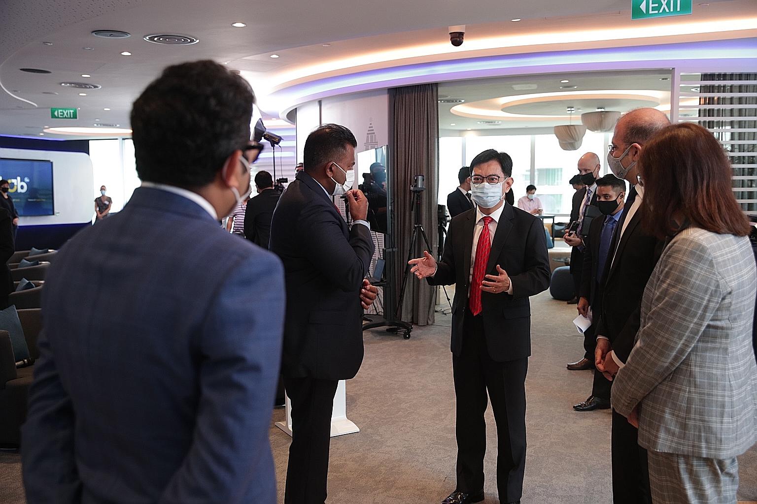 Deputy Prime Minister Heng Swee Keat interacting with guests during the launch of iLab 2021, a virtual innovation festival organised by American consumer goods giant Procter & Gamble in partnership with the Economic Development Board.