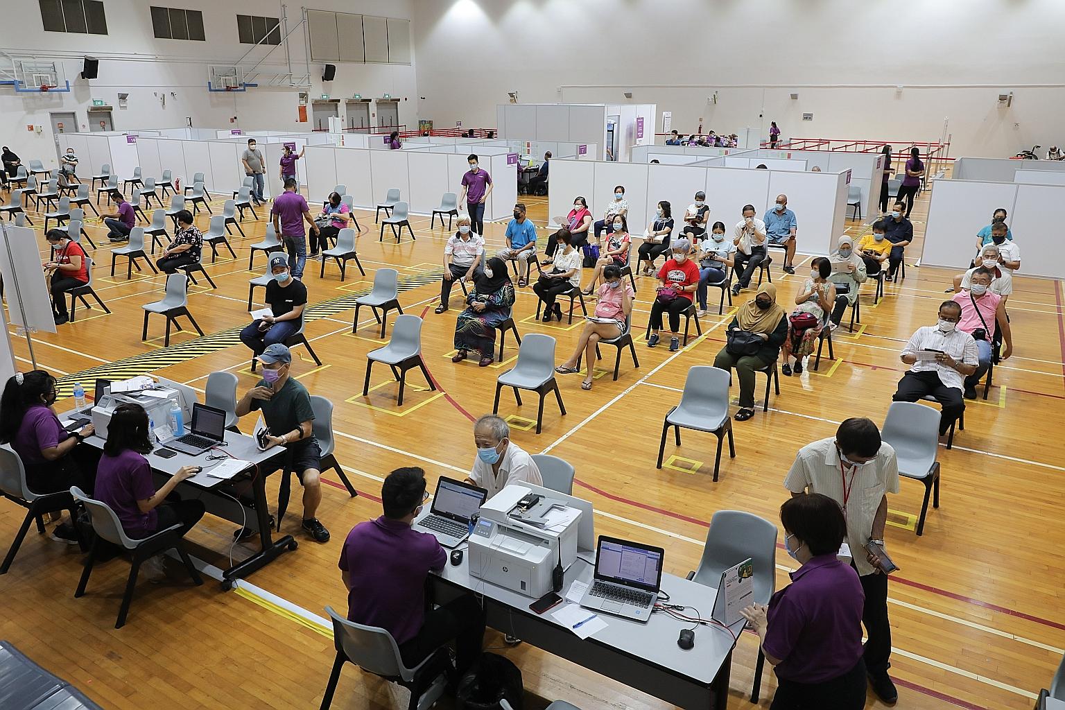 People in the observation area after receiving their Covid-19 vaccine jab at Senja-Cashew Community Club in March. Health Minister Gan Kim Yong said yesterday that Singapore has not seen any local cases of unusual blood clots associated with low plat