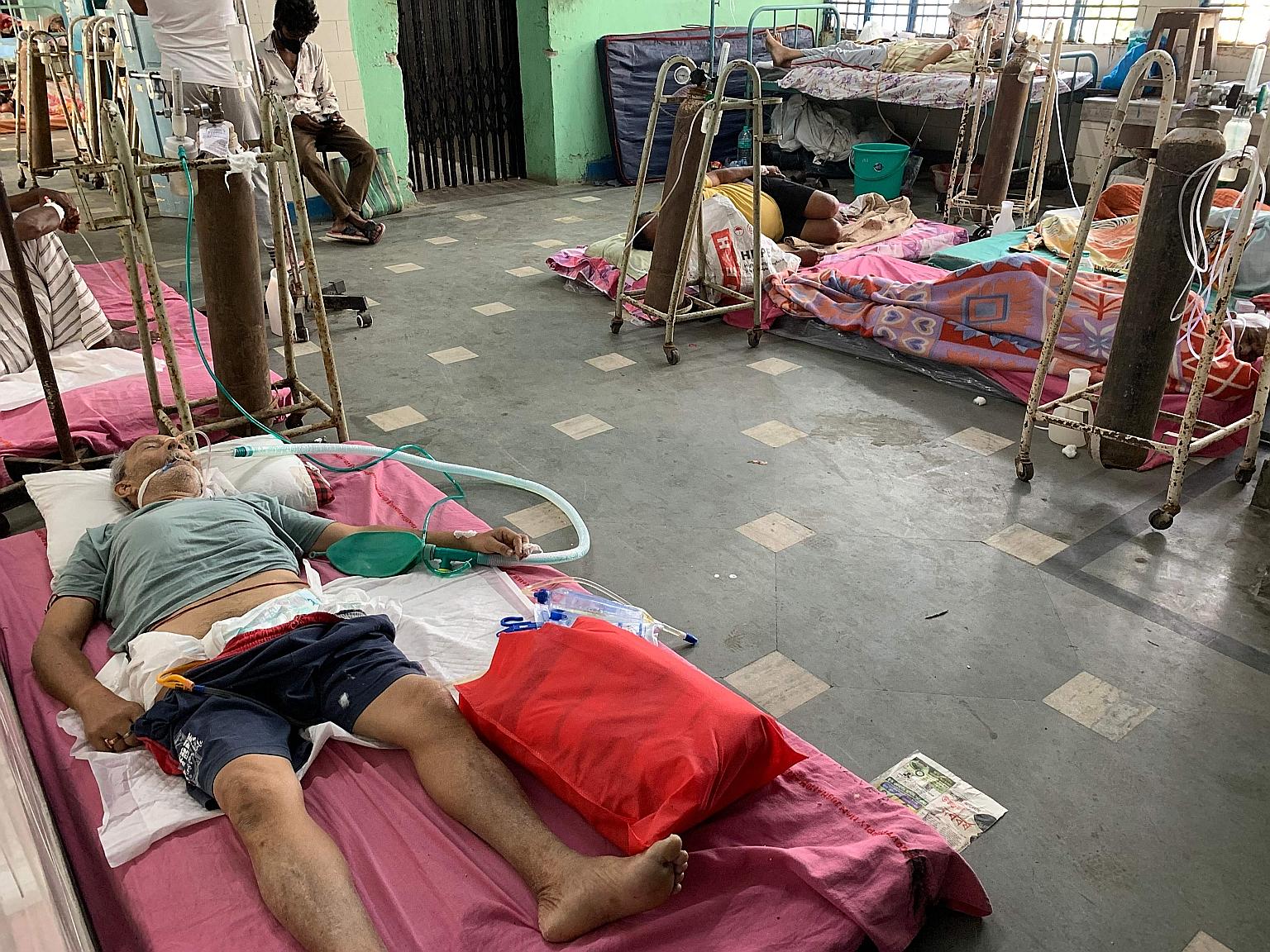 Coronavirus patients at a hospital in Siliguri, India, yesterday. Experts have highlighted that the more the coronavirus spreads, the bigger the risk that it will find ideal conditions to mutate in concerning ways. They emphasise that everything must