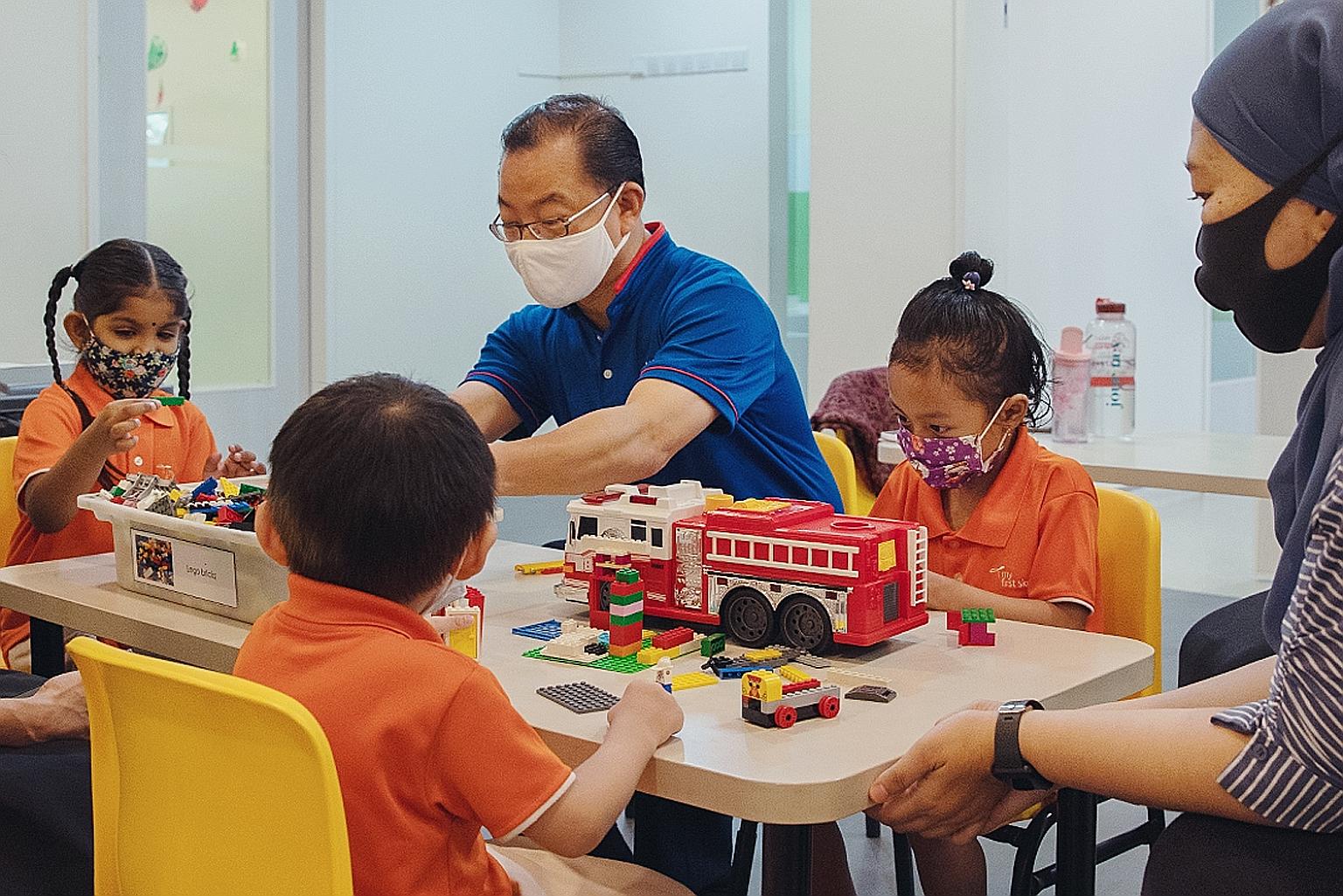 Mr Seah Kian Peng, Group CEO of NTUC Enterprise, with children who attend My First Skool. Needy families with a child enrolled in any of the My First Skool pre-school centres stand to benefit from the $350,000 Food and Nutrition Programme.