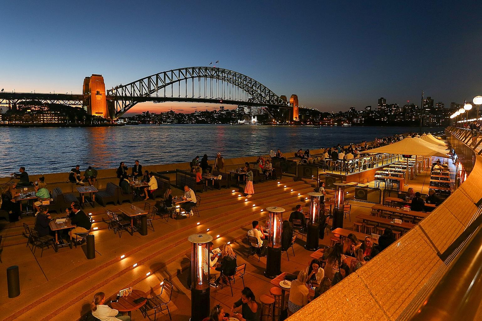 Diners at the forecourt of Sydney Opera House late last month. Australia's budget released this week revealed that, in the year to July, the ruling coalition expects the country's deficit to reach A$161 billion (S$165.5 billion), or 8 per cent of gro