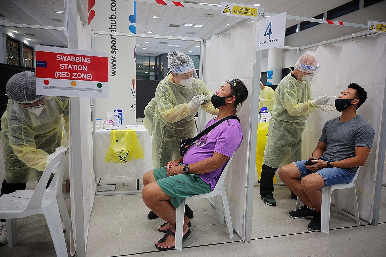 Fans being swabbed for the antigen rapid test (ART) before attending the Singapore Tennis Open event in February. Unlike the polymerase chain reaction (PCR) test, which requires swabs to be sent to laboratories, ART can be done on-site and produce re