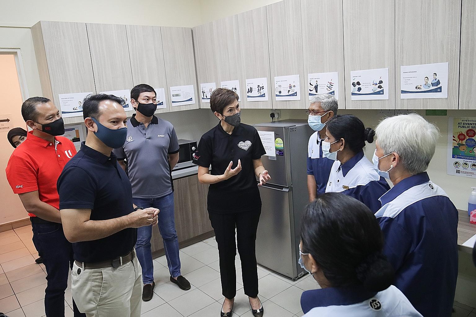 Outgoing Manpower Minister Josephine Teo and Senior Minister of State for Manpower Zaqy Mohamad (second from left) interacting with cleaners in their rest area in Jurong Point yesterday. The mall's owner has equipped its four rest areas for outsource
