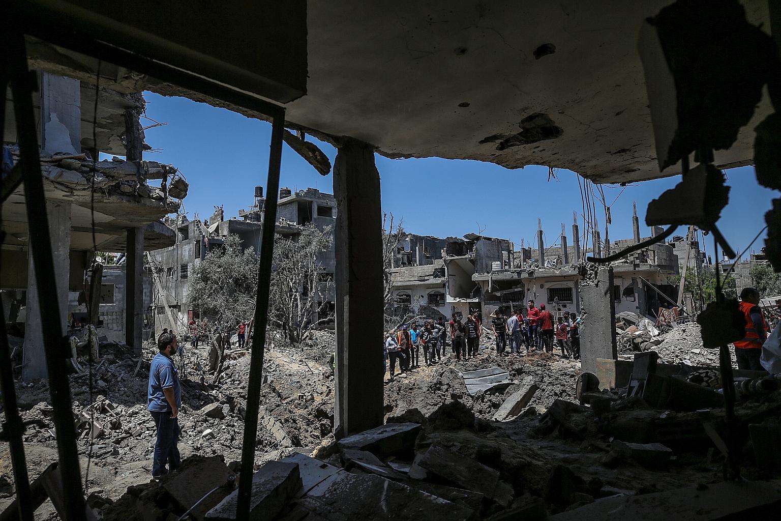 Palestinians surveying the damage after their homes were destroyed by Israeli air strikes in Beit Hanun town in the northern Gaza Strip yesterday. At least 122 people have been killed in Gaza and 900 others wounded, Palestinian medical officials said
