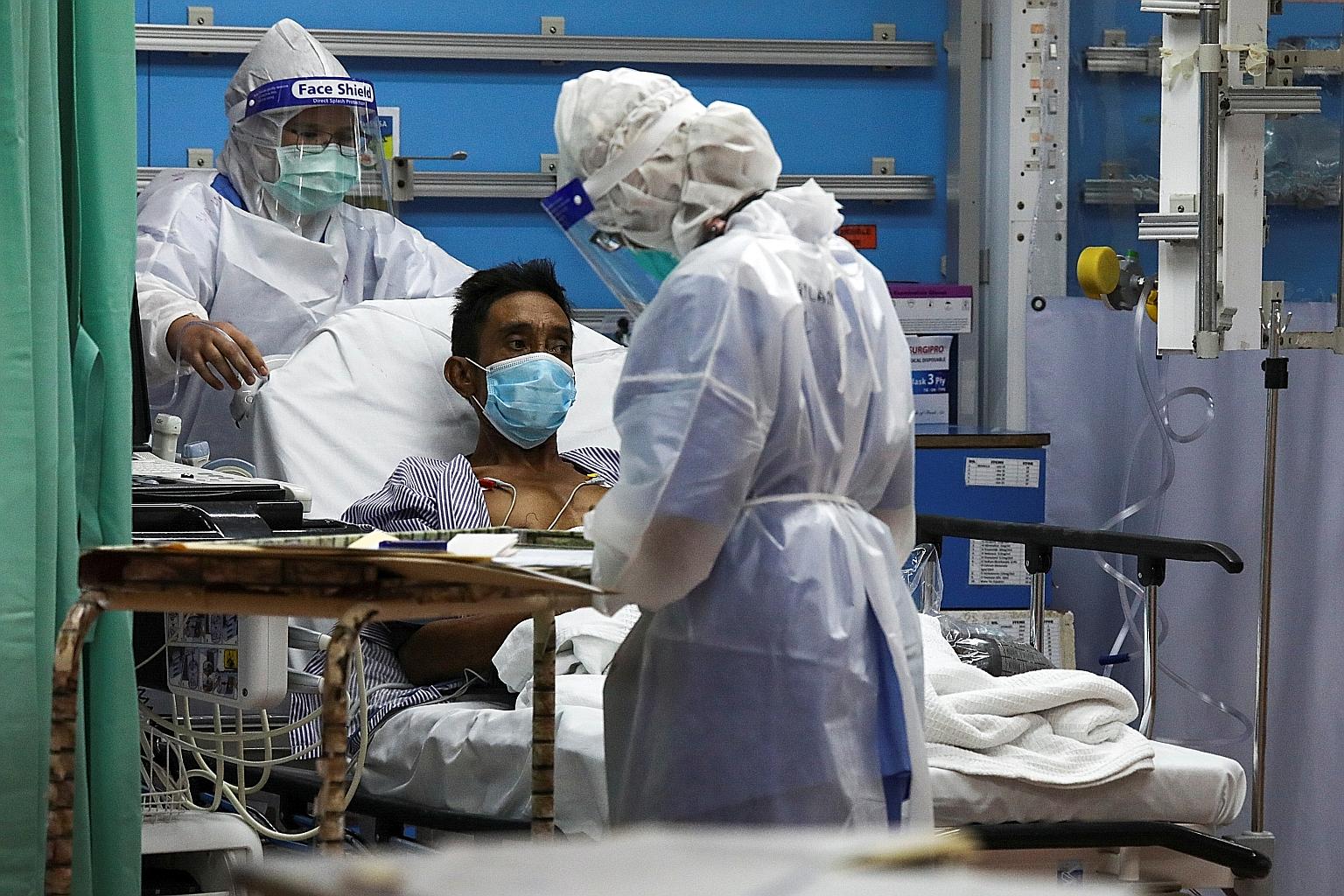 Medical workers examining a patient at Kuala Lumpur Hospital's emergency department in the Malaysian city in February.