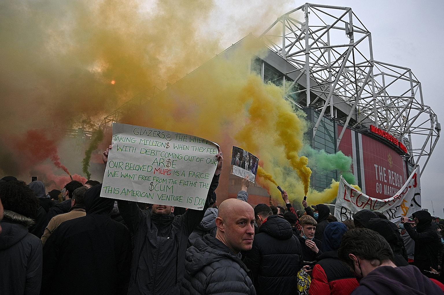 Demonstrators letting off flares outside Old Trafford to protest against Manchester United's owners, the Glazer family, ahead of the Red Devils' English Premier League match against Liverpool on Thursday. PHOTO: AGENCE FRANCE-PRESSE