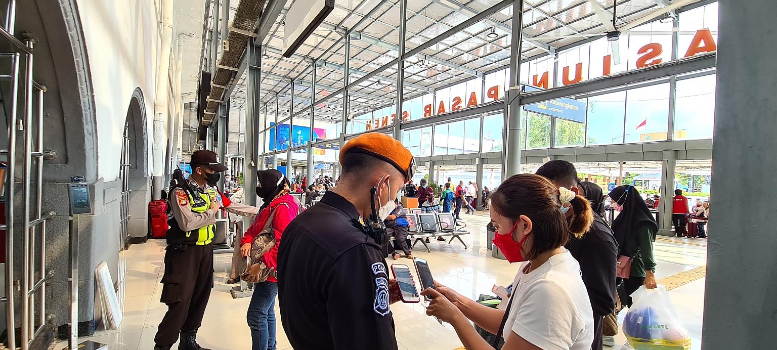 A passenger showing her ticket to an officer at Jakarta's Pasar Senen train station on May 4. At the end of Ramadan each year, millions living in Jakarta make their way home in a massive exodus to celebrate Aidilfitri. ST PHOTO: LINDA YULISMAN