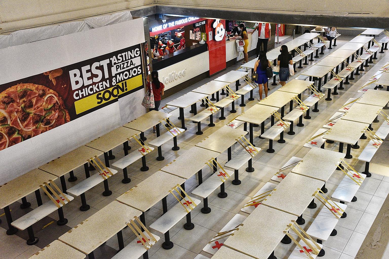 Only a few customers were seen at the basement foodcourt of Lucky Plaza (above) yesterday at 5pm. Eateries in Orchard Road malls such as Ion Orchard and Takashimaya saw a dip in sales, with some even rolling out takeaway discounts of 20 per cent to 2