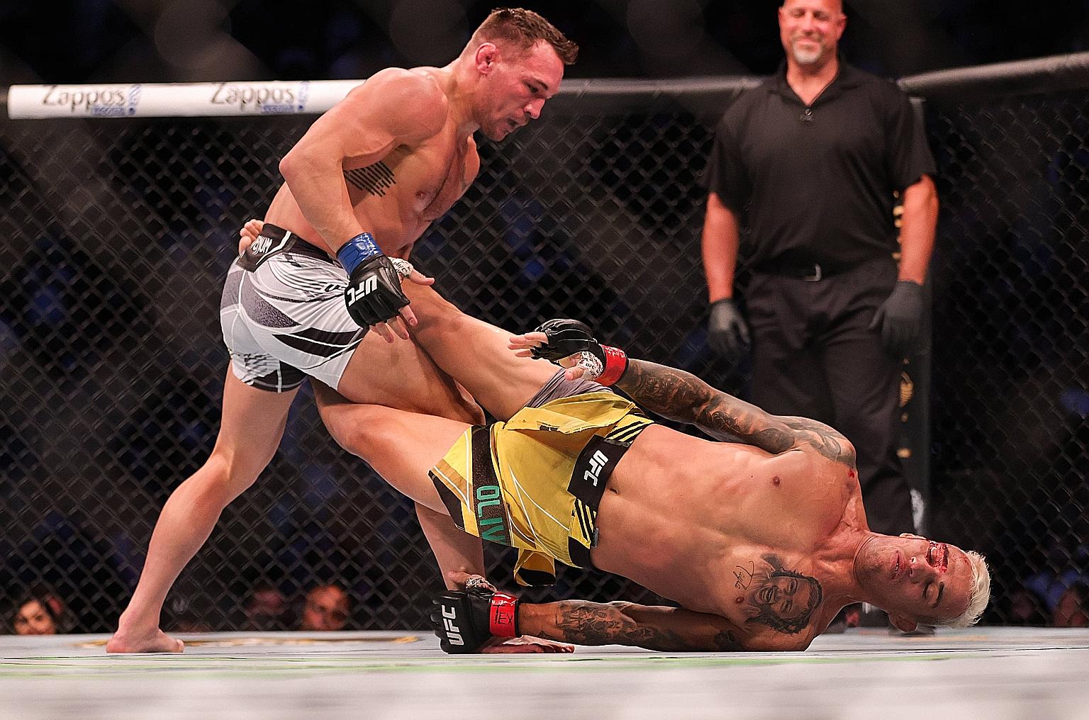 Charles Oliveira (in yellow) survived an early onslaught by Michael Chandler to deliver one of the best short fights in Ultimate Fighting Championship (UFC) history at UFC 262 in Texas on Saturday. The Brazilian won the lightweight title just 19 seco