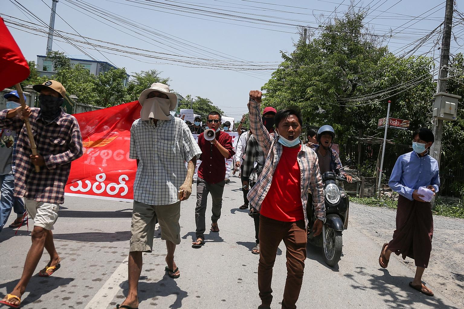 Demonstrators during an anti-military coup protest in Mandalay, Myanmar, yesterday. Some in the anti-junta movement have set up local militias armed with home-made weapons to protect their towns from security forces.
