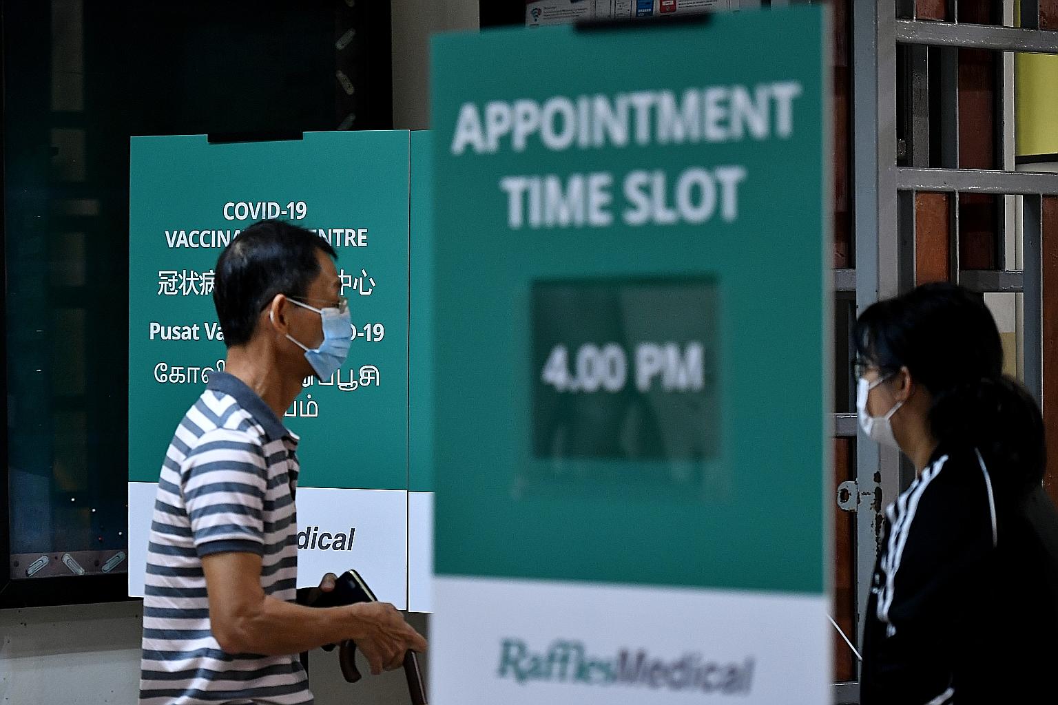 People at the Covid-19 vaccination centre at Hong Kah North Community Club in March. So far, 1.4 million individuals here have had both doses of the vaccine. Another 600,000 have had one dose, and they can get their second as scheduled. But they can 