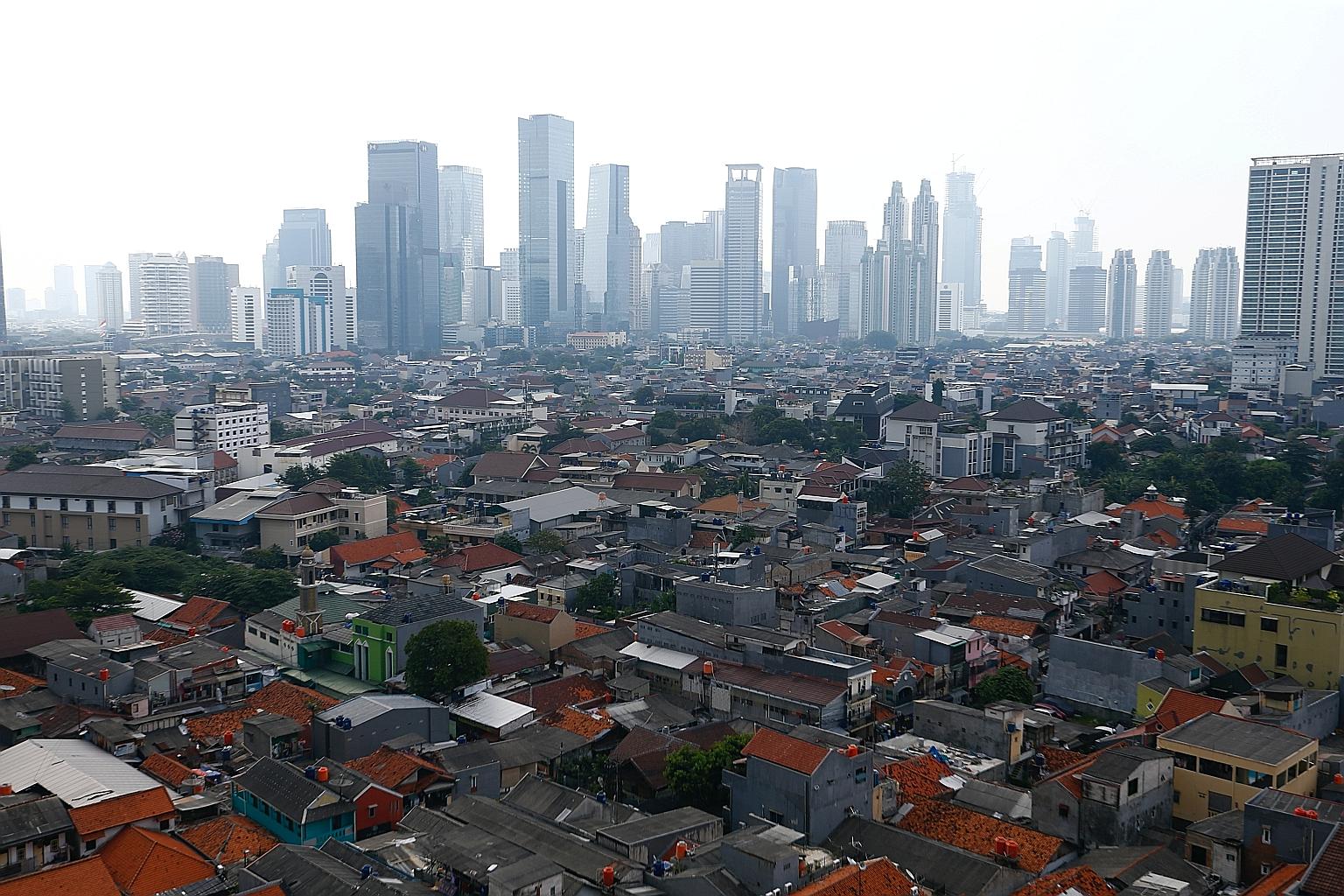 Smog engulfing office buildings in Jakarta, Indonesia. Rapid urbanisation and chronic traffic are contributing factors to poor air quality in the city, alongside nearby coal-fired power plants, according to the Centre on Energy and Clean Air. PHOTO: 