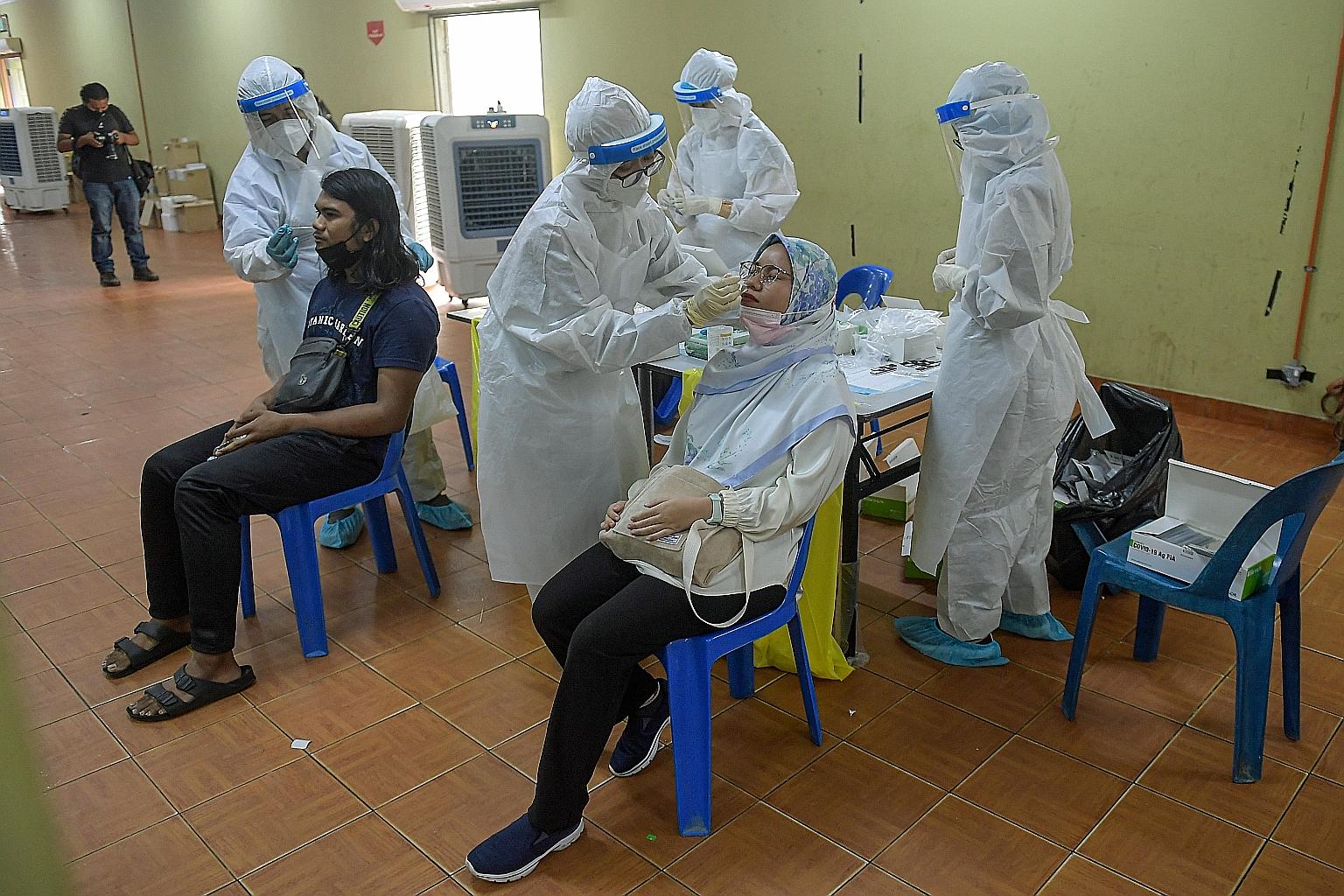 Residents of Sungai Tua constituency in Selangor getting free Covid-19 swabs as part of health checks in 56 of the Malaysian state's wards. With the number of daily infections rising, several states, including Selangor, are rushing to procure their o