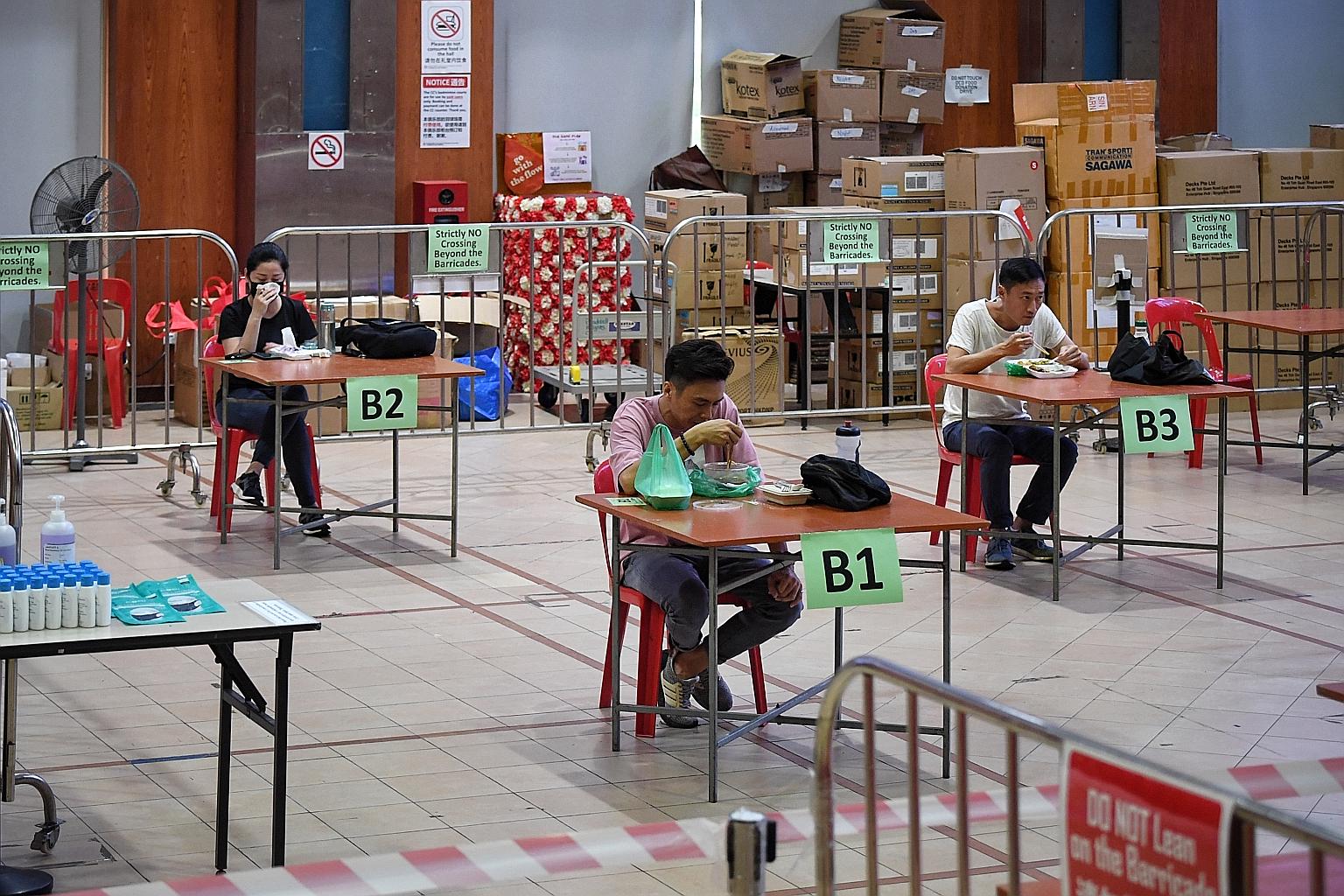 Safe distancing ambassadors having their lunch at Braddell Heights Community Club's multi-purpose hall yesterday. ST PHOTO: KUA CHEE SIONG